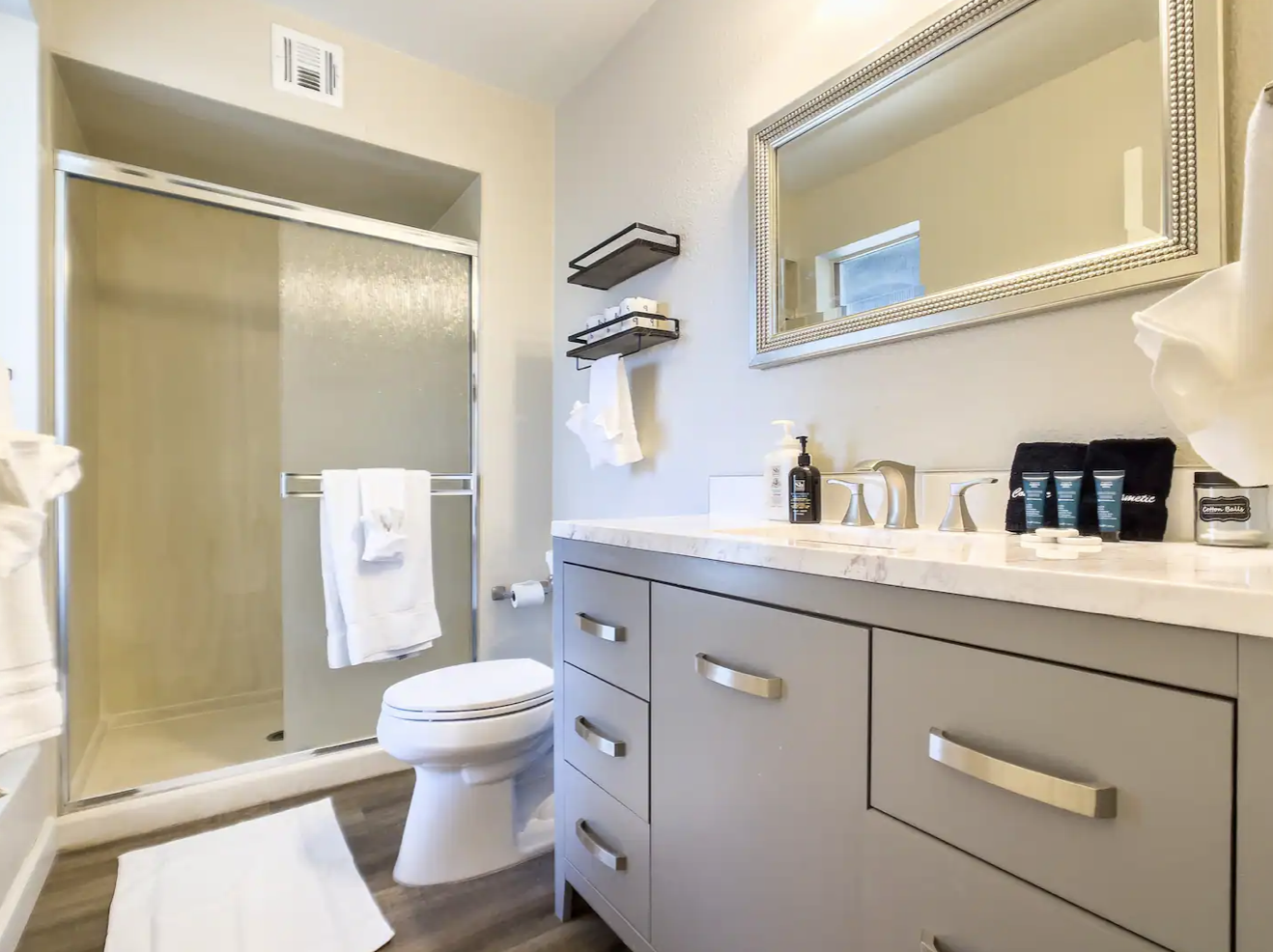 Two full bathrooms are stocked with items including: shampoo, conditioner, body wash, and fresh towels.