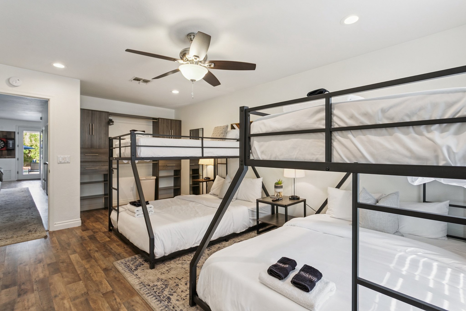 Gather your crew in this stylish bunk room where modern metal frames and cozy white linens create the perfect sleepover vibes.