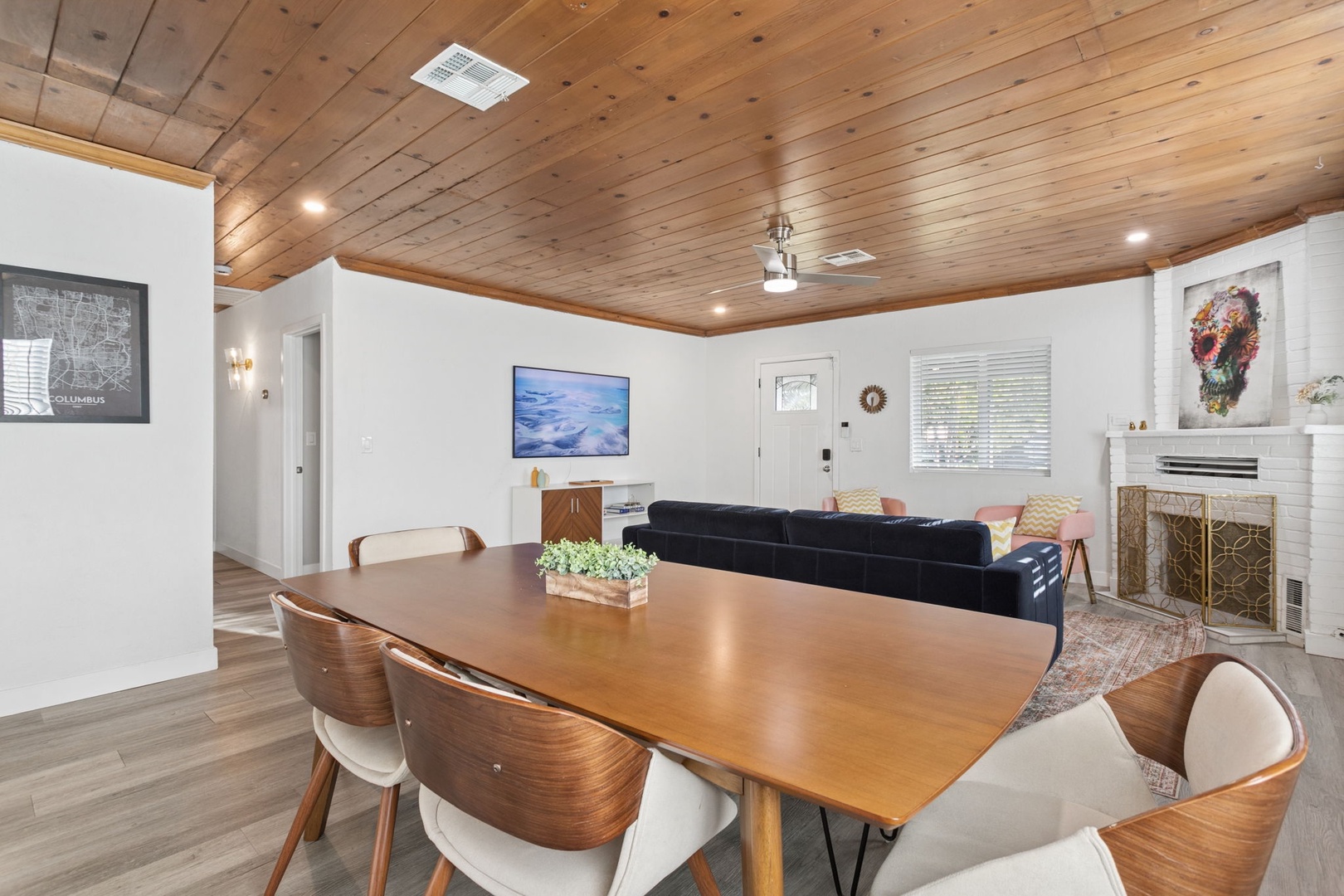 Your open-concept living space combines warm wood accents with modern comfort, featuring dining and lounge areas perfect for memorable gatherings.