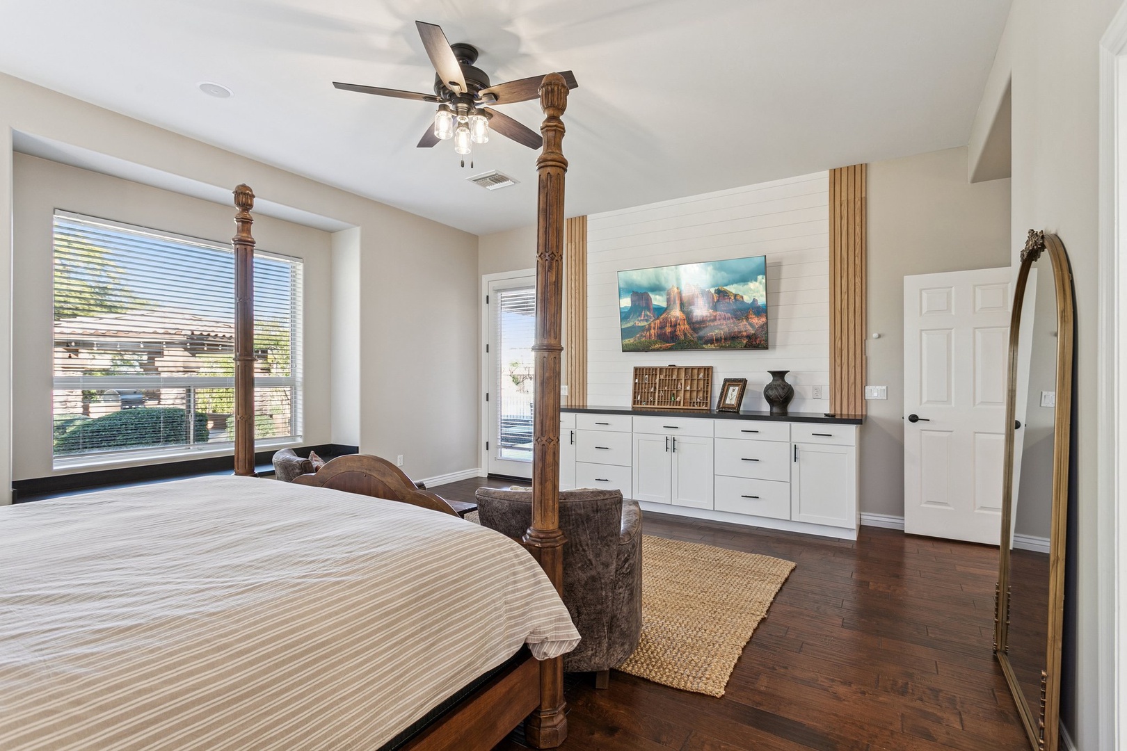 Your spacious bedroom features a stunning four-poster bed, custom built-ins, and a cozy seating area where you can unwind after exploring.