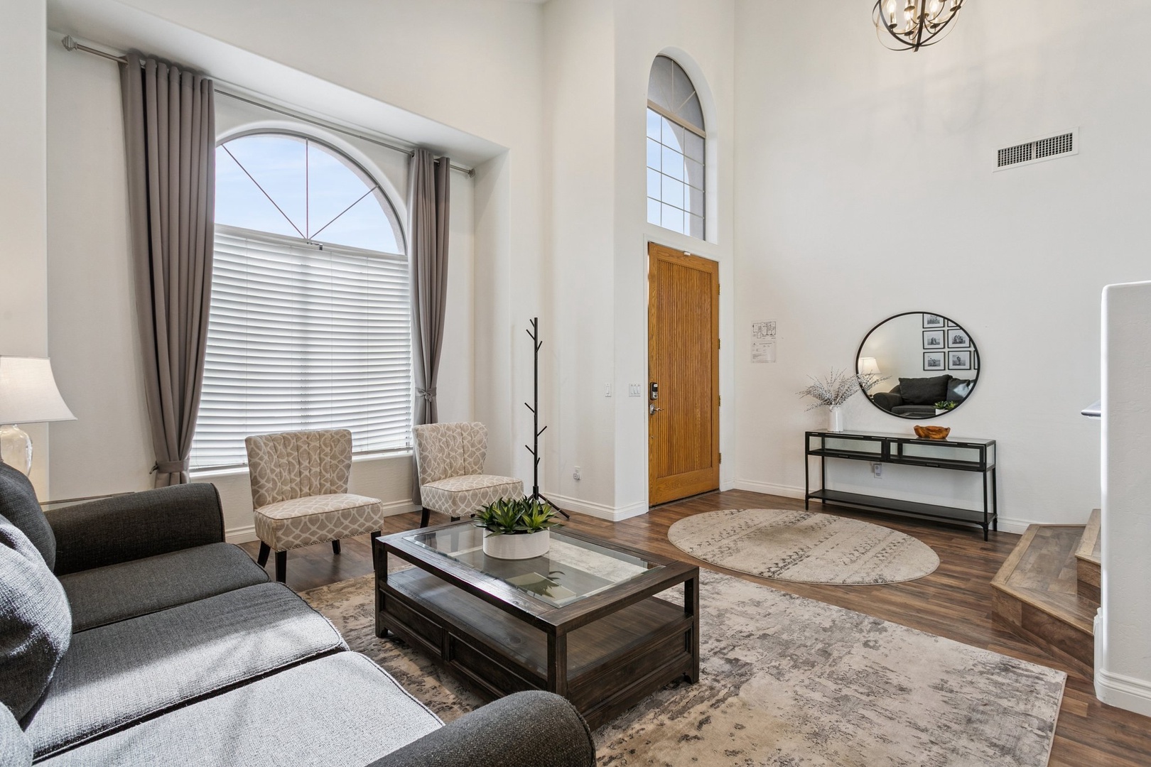 Relax in your spacious living room with soaring ceilings and elegant arched windows that fill the space with natural light.