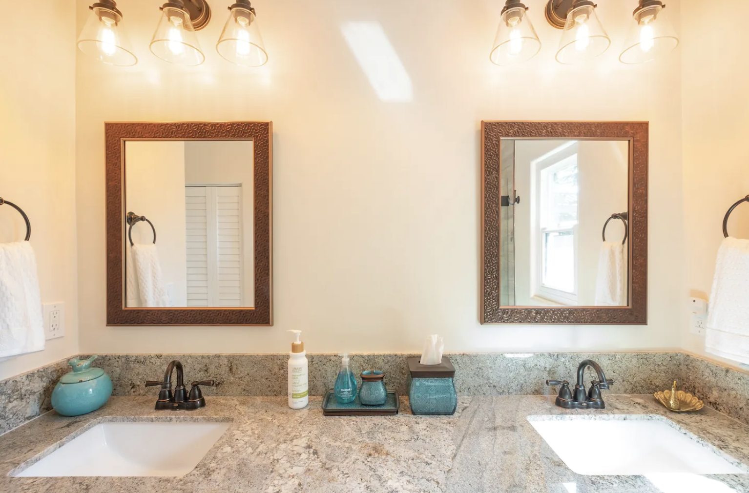 The master bathroom is equipped with shower, fresh laundered towels, hand soap, body wash, shampoo, conditioner, and body lotion.