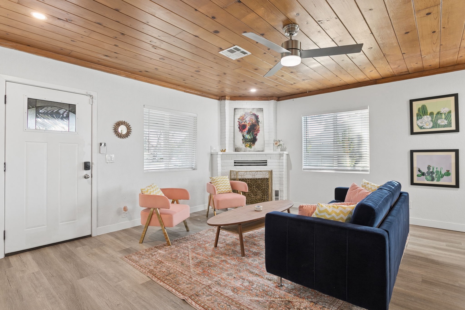 Relax in your stylish living room beneath stunning wood ceilings, where modern comfort meets warm rustic charm.