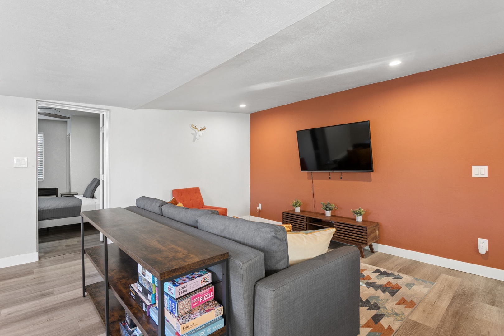 Unwind on your plush gray convertible sofa bed while watching your favorite shows on the wall-mounted TV.