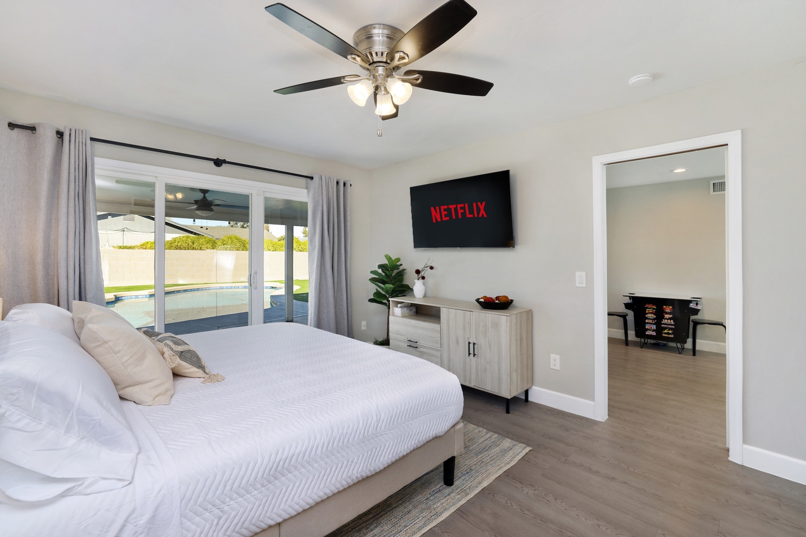Large Master Bedroom with King bed, 55" Smart Roku UHD TV, with direct access to the covered patio and pool.