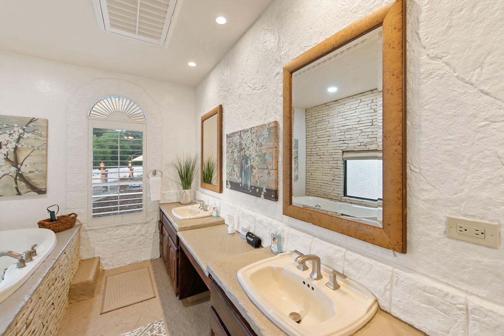 Unwind in your spa-like bathroom with vanities (left sink out of order), soaking tub, and natural stone accents creating the perfect retreat.