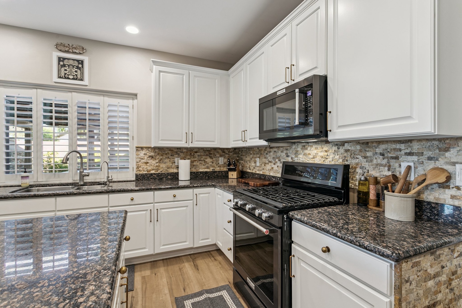 Your gourmet kitchen awaits with granite counters, modern appliances, and elegant tile backsplash—perfect for preparing memorable meals during your stay.