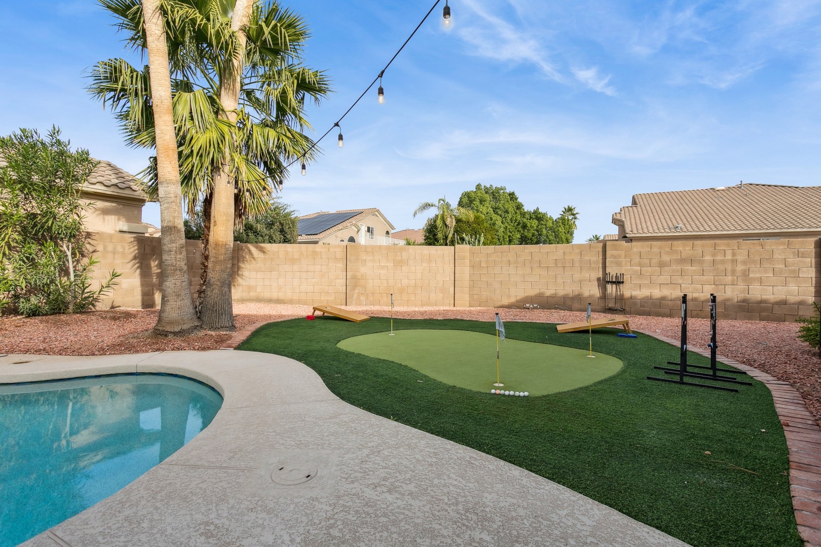 Your private backyard oasis features a sparkling pool and putting green where you can perfect your golf game between refreshing dips.