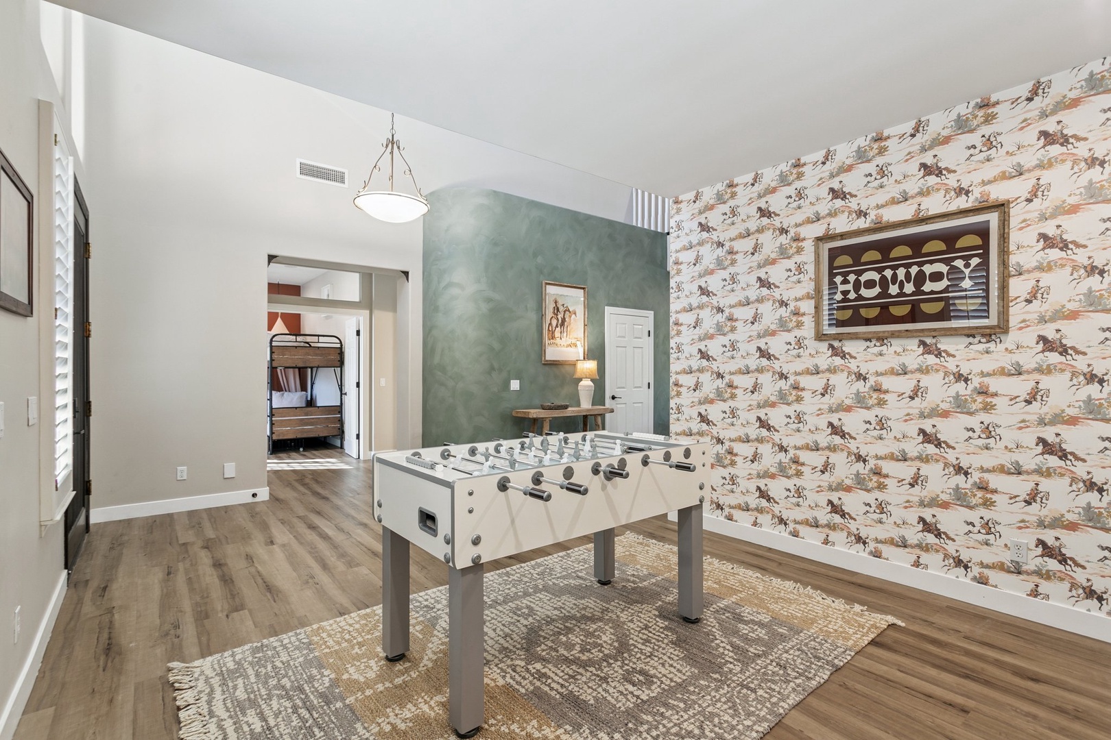 Challenge friends to foosball in your stylish game room, complete with western-themed decor and open flow to bunk bed room.