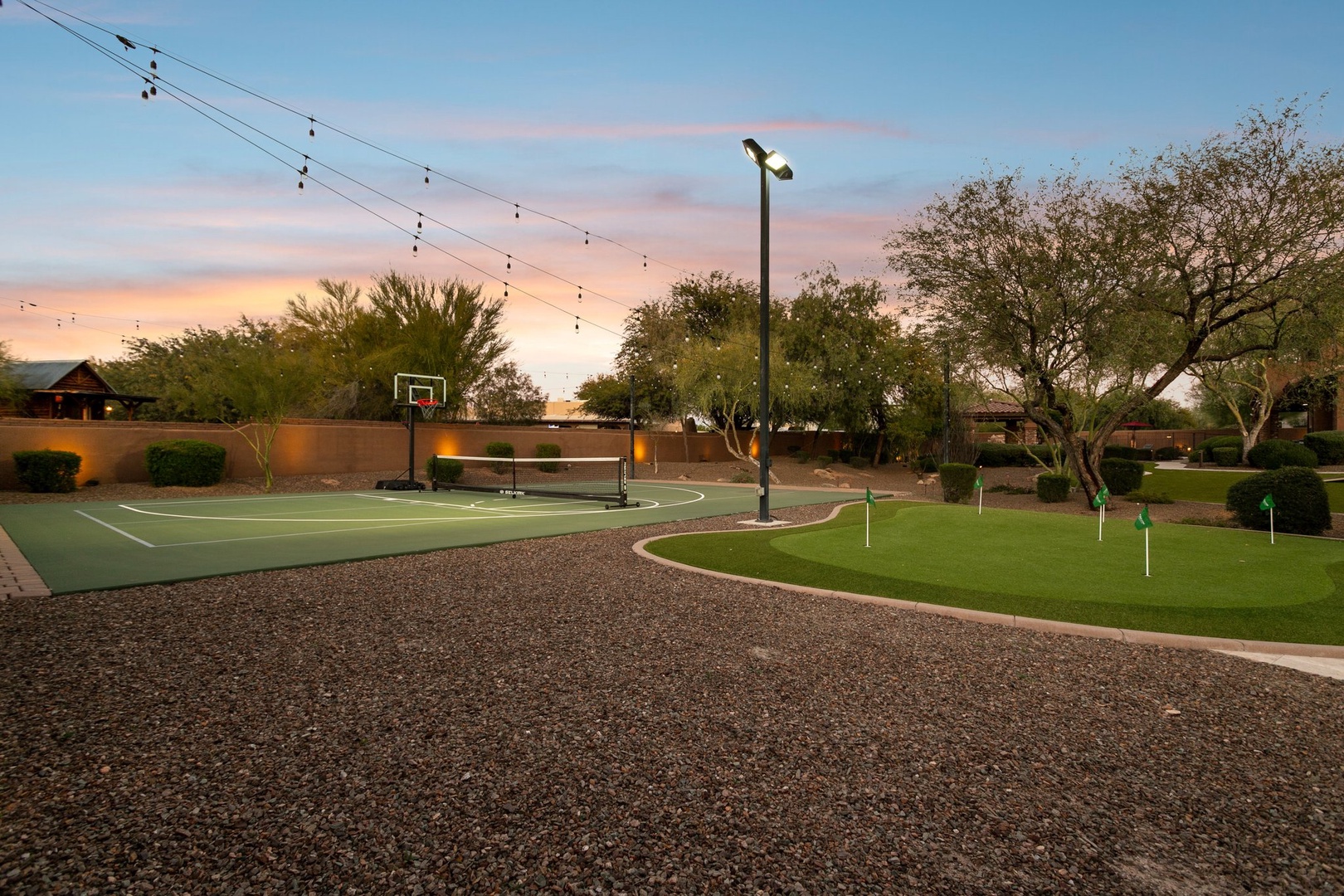 Private recreational area featuring basketball court and putting green