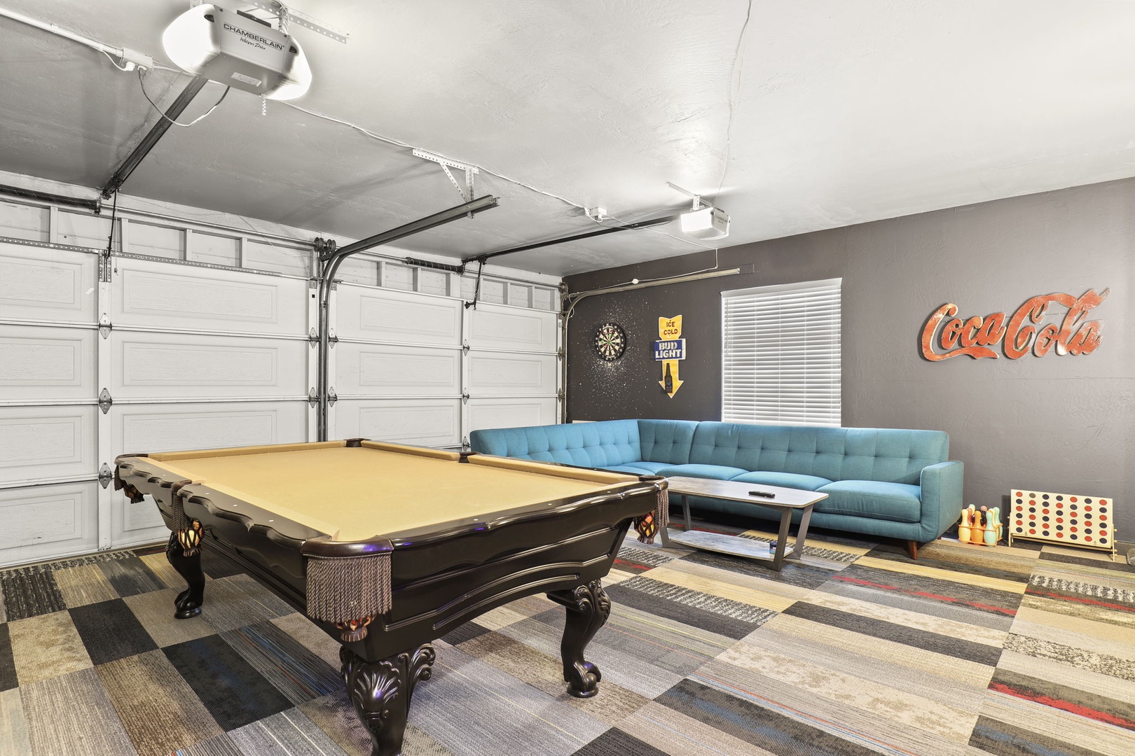 Temperature controlled game room with sofa sectional lounge, pool table, dart board, big screen smart tv.