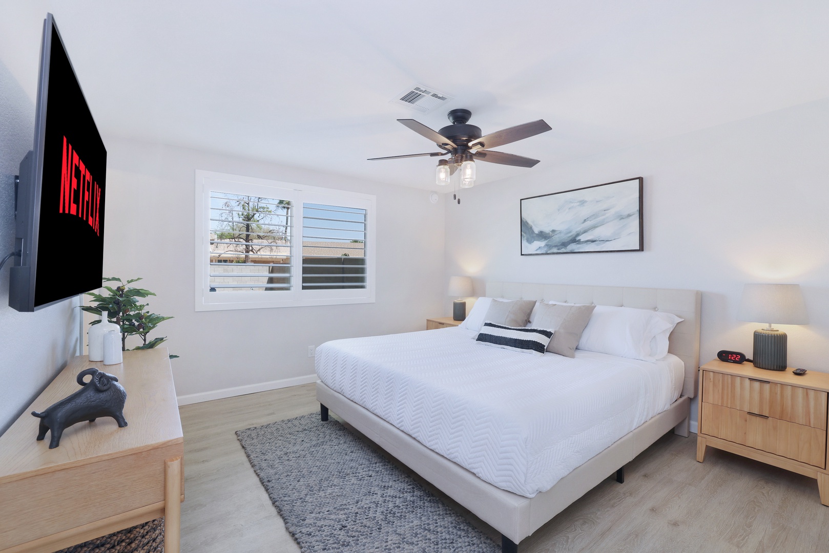 Master bedroom with a king size bed, clothing storage and TV.