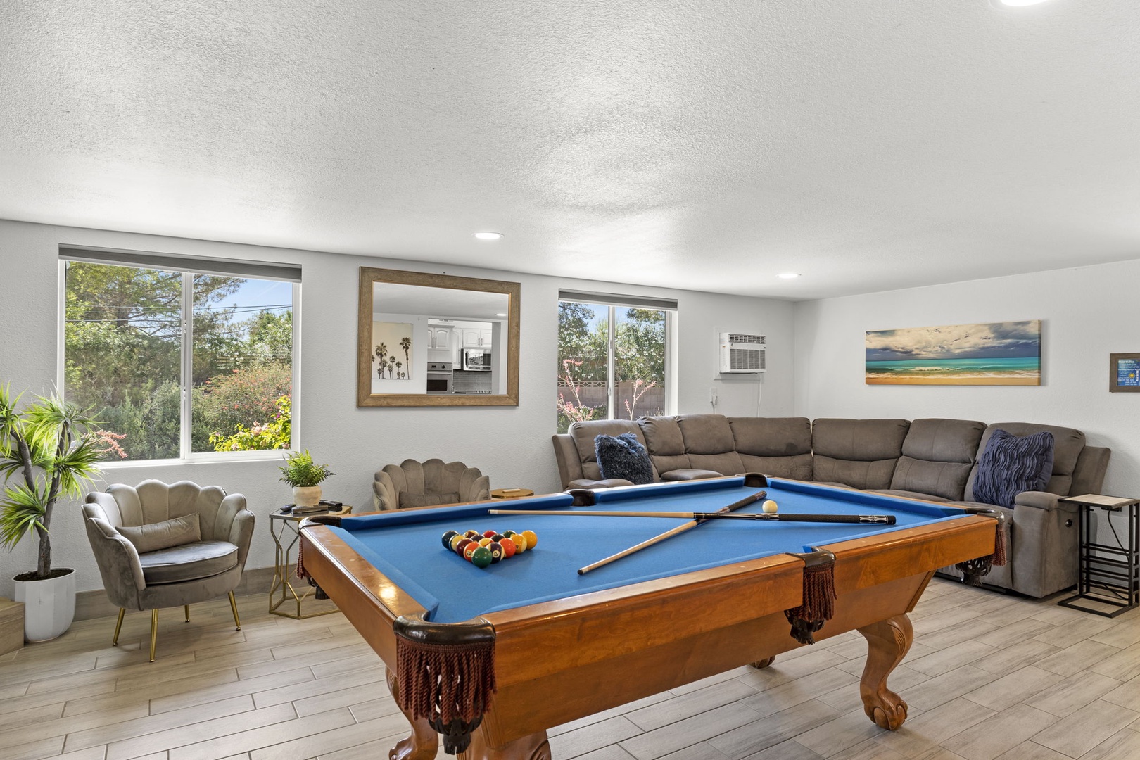 Game room with pool table and additional living area.