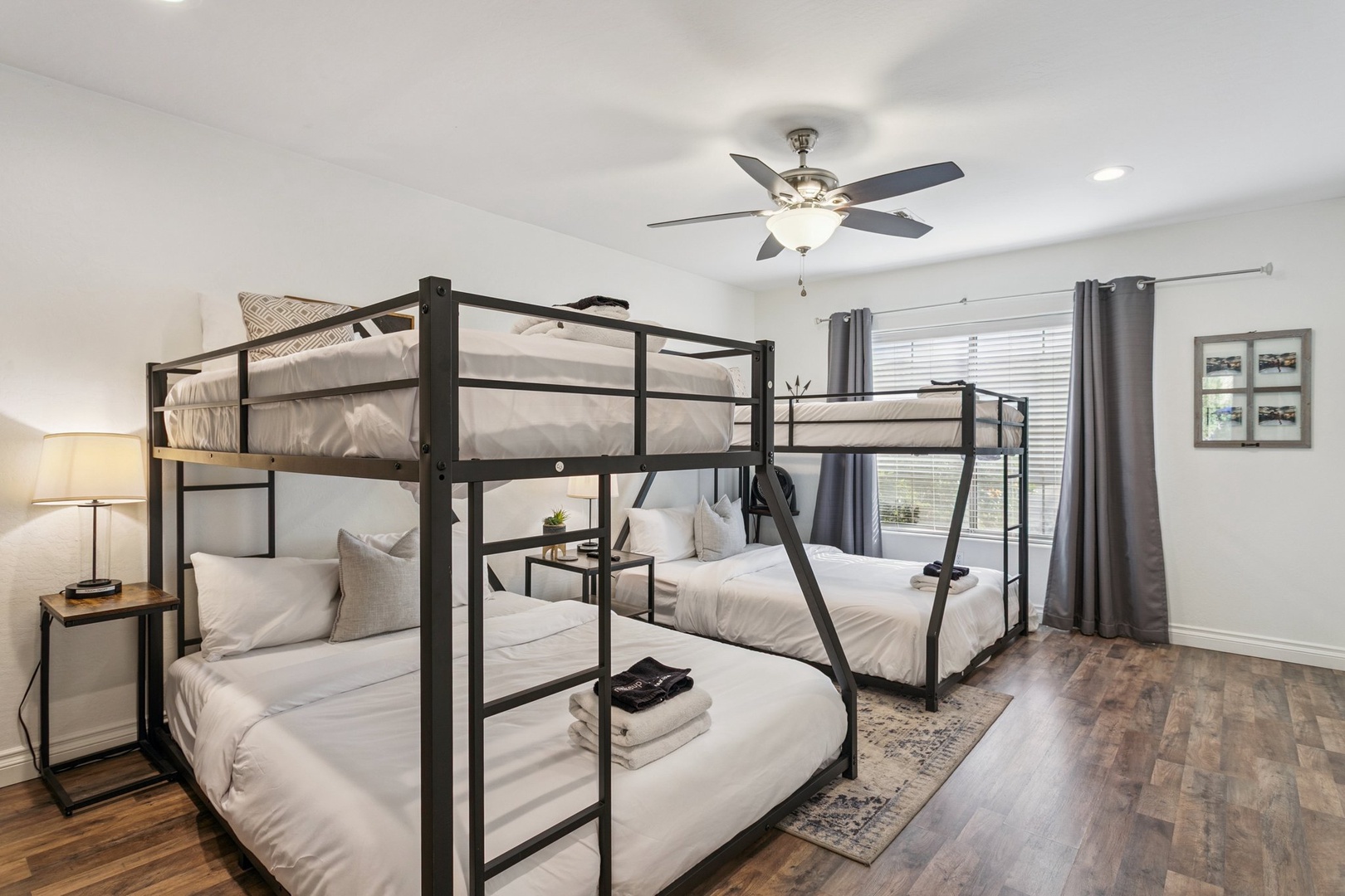 Your spacious bunk room combines comfort with fun, featuring plush white bedding, modern lighting, and a ceiling fan for perfect temperature control.