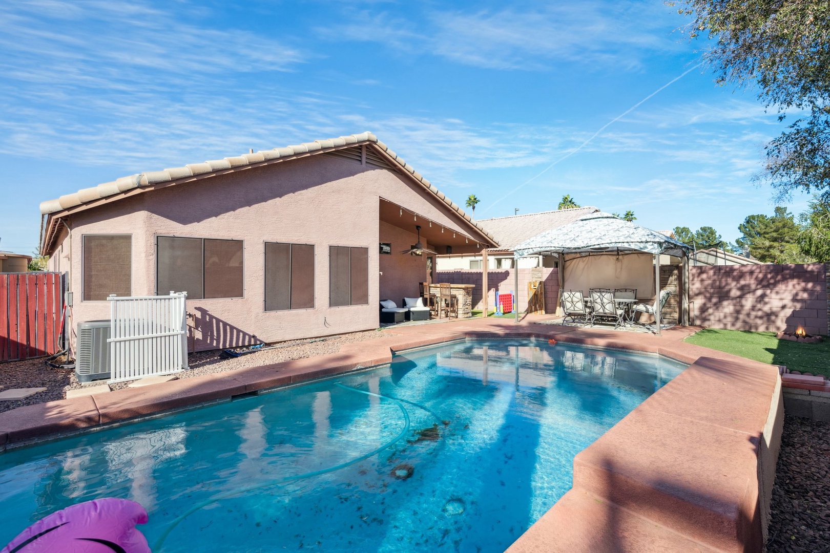 Desert retreat with sparkling pool, covered patio, and mountain views under endless Arizona skies.