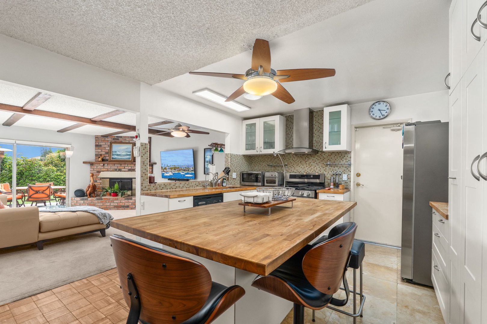 Your open-concept kitchen flows beautifully into the living area, featuring a warm wood island where you can gather for meals.