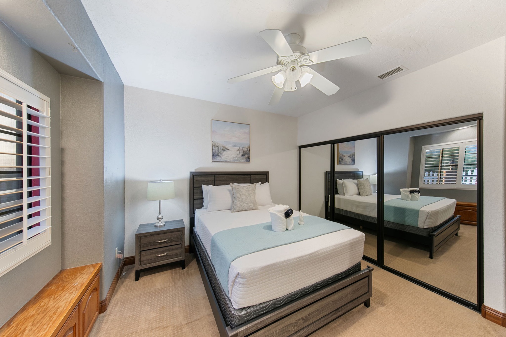 Rest peacefully in your serene bedroom with crisp linens, gentle ceiling fan, and mirrored closets that amplify the calming coastal vibes.