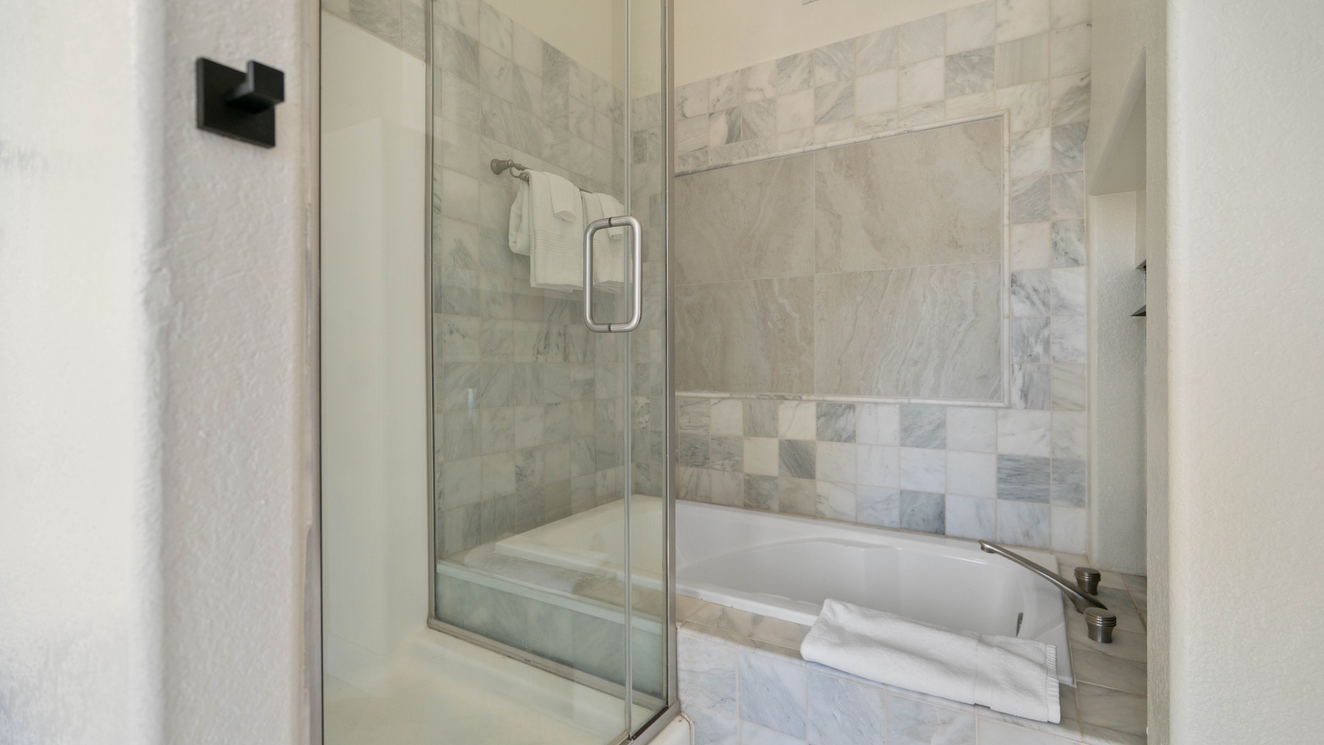 Primary Bedroom ensuite bathroom featuring a walk-in shower and soaking tub with see through fireplace