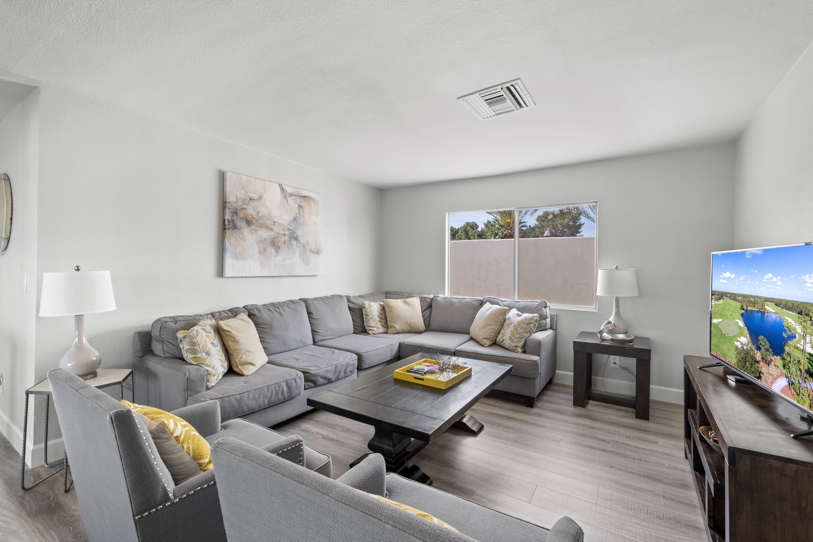 Large sectional sofa and chairs with a smart tv with streaming services.