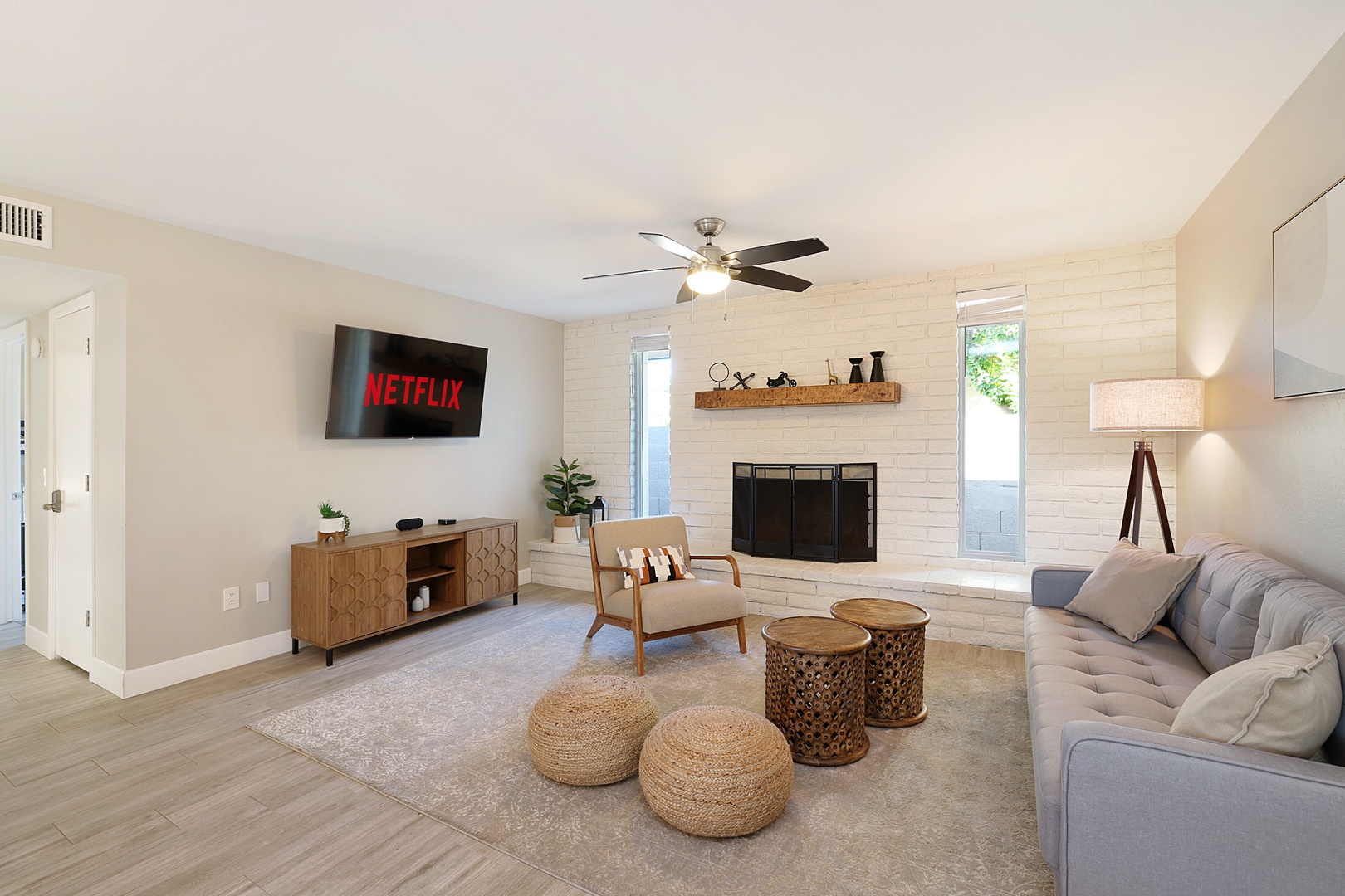 You'll find a comfortable sofa and additional seating along with a huge flat screen tv connected to streaming services.