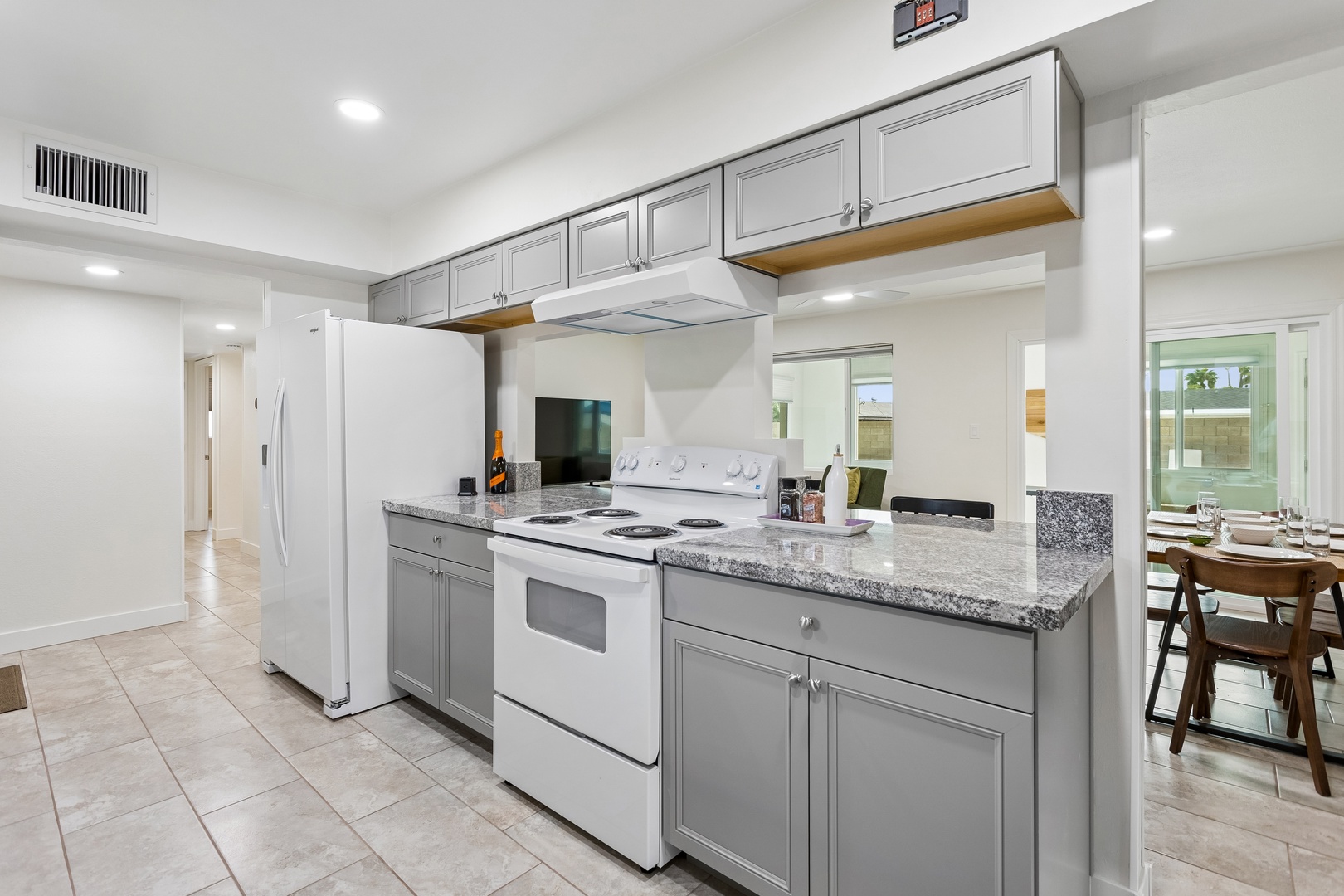 Your fully equipped kitchen awaits with granite countertops, modern appliances, and plenty of storage—perfect for preparing meals or gathering with loved ones over morning coffee.