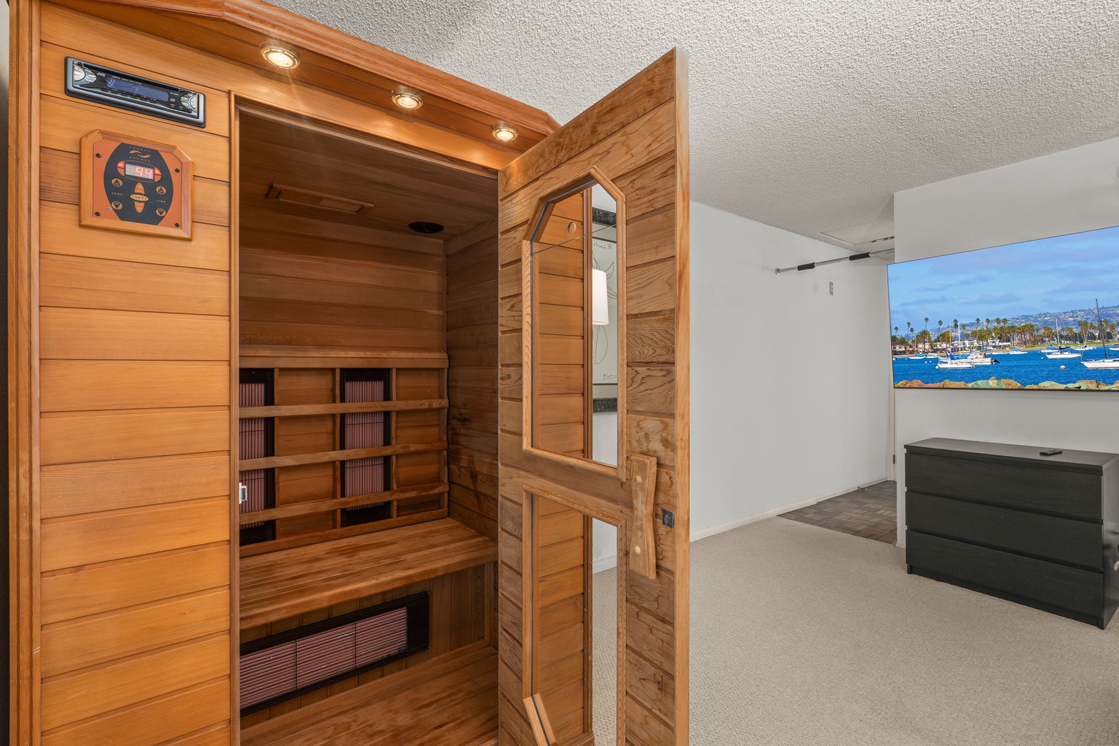 Unwind in your private infrared sauna after exploring, then relax in the modern bedroom with stunning ocean views.