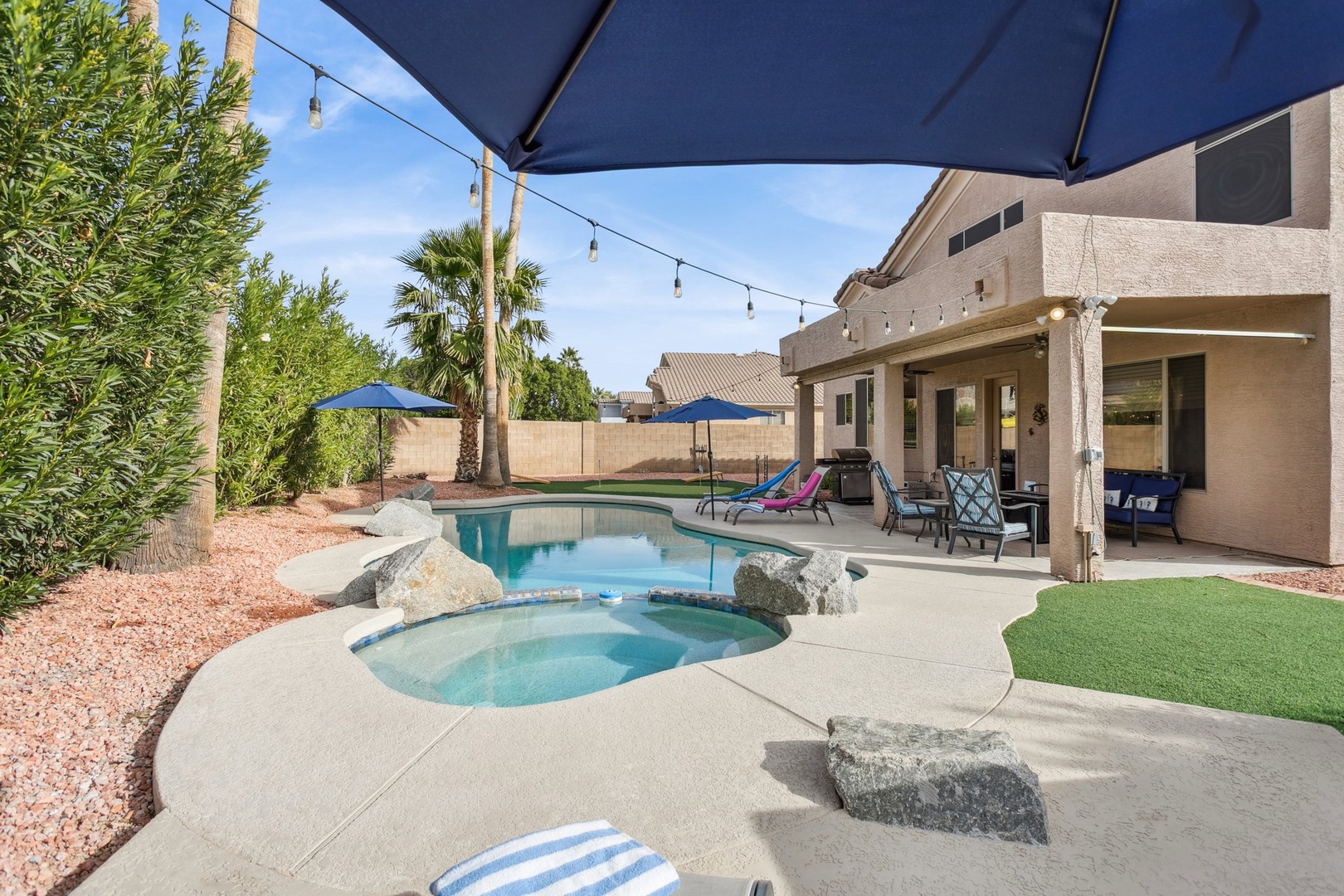 Dive into your private oasis with sparkling pool and hot tub, perfect for sunny afternoons under desert palms.