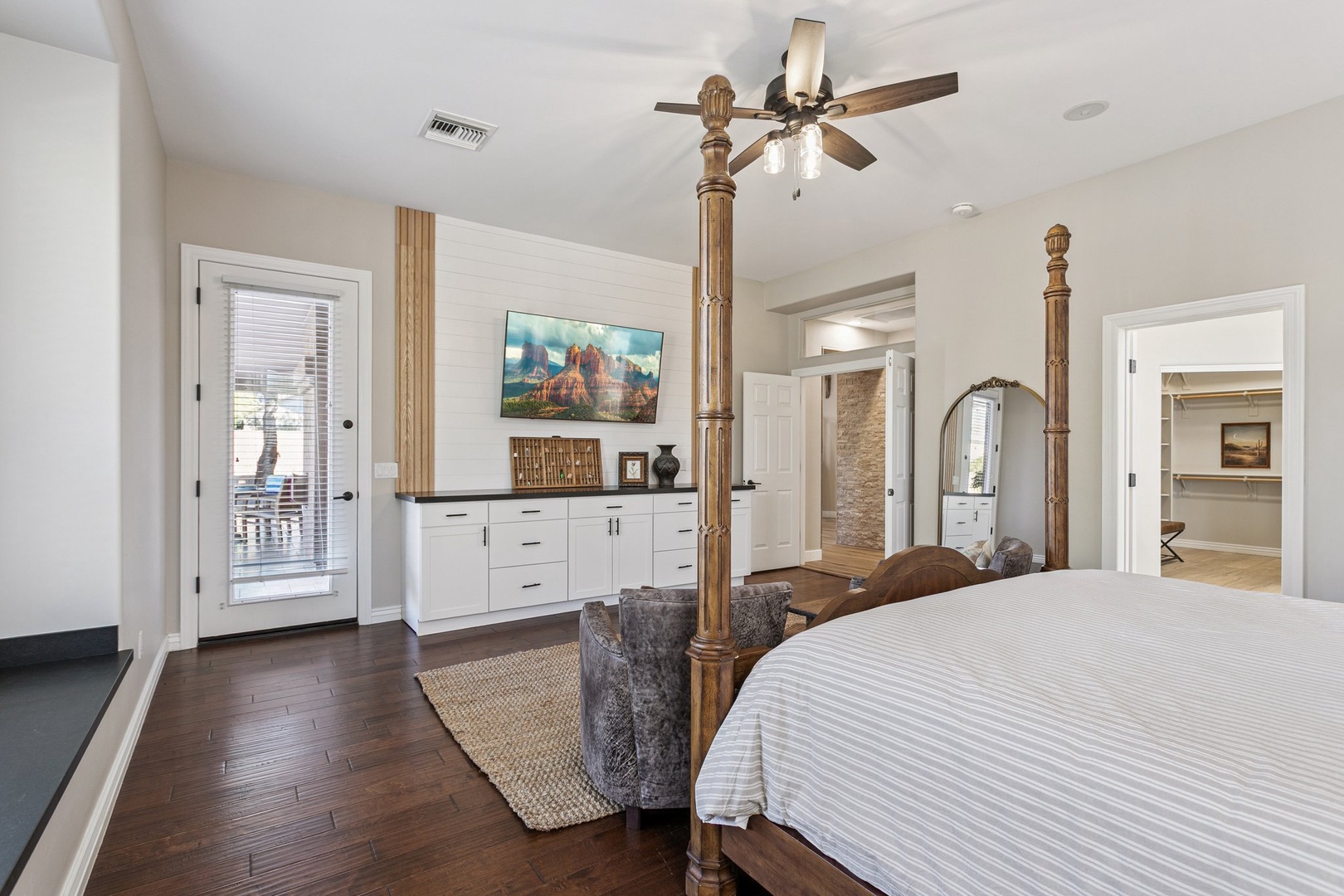 Your spacious bedroom offers comfort with a beautiful four-poster bed, private balcony access, and calming design details for restful nights.