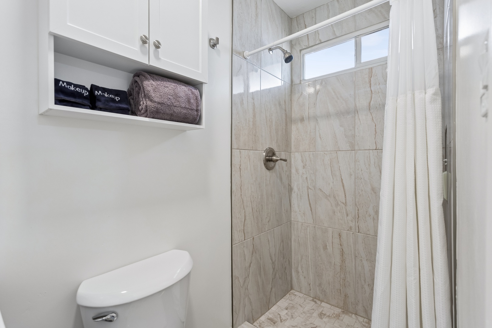 Freshen up in your modern bathroom featuring a spacious walk-in shower and thoughtful storage, all finished in soothing neutral tones to help you unwind.