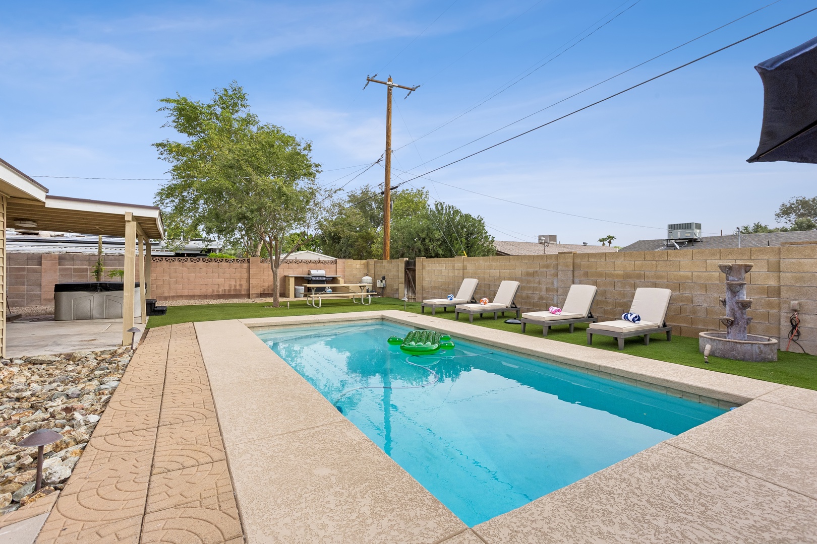 Your private oasis awaits with a sparkling pool surrounded by plush loungers and peaceful greenery. Spend sun-soaked days floating on turquoise waters, grilling under the covered patio, or simply relaxing in your fully fenced backyard retreat.