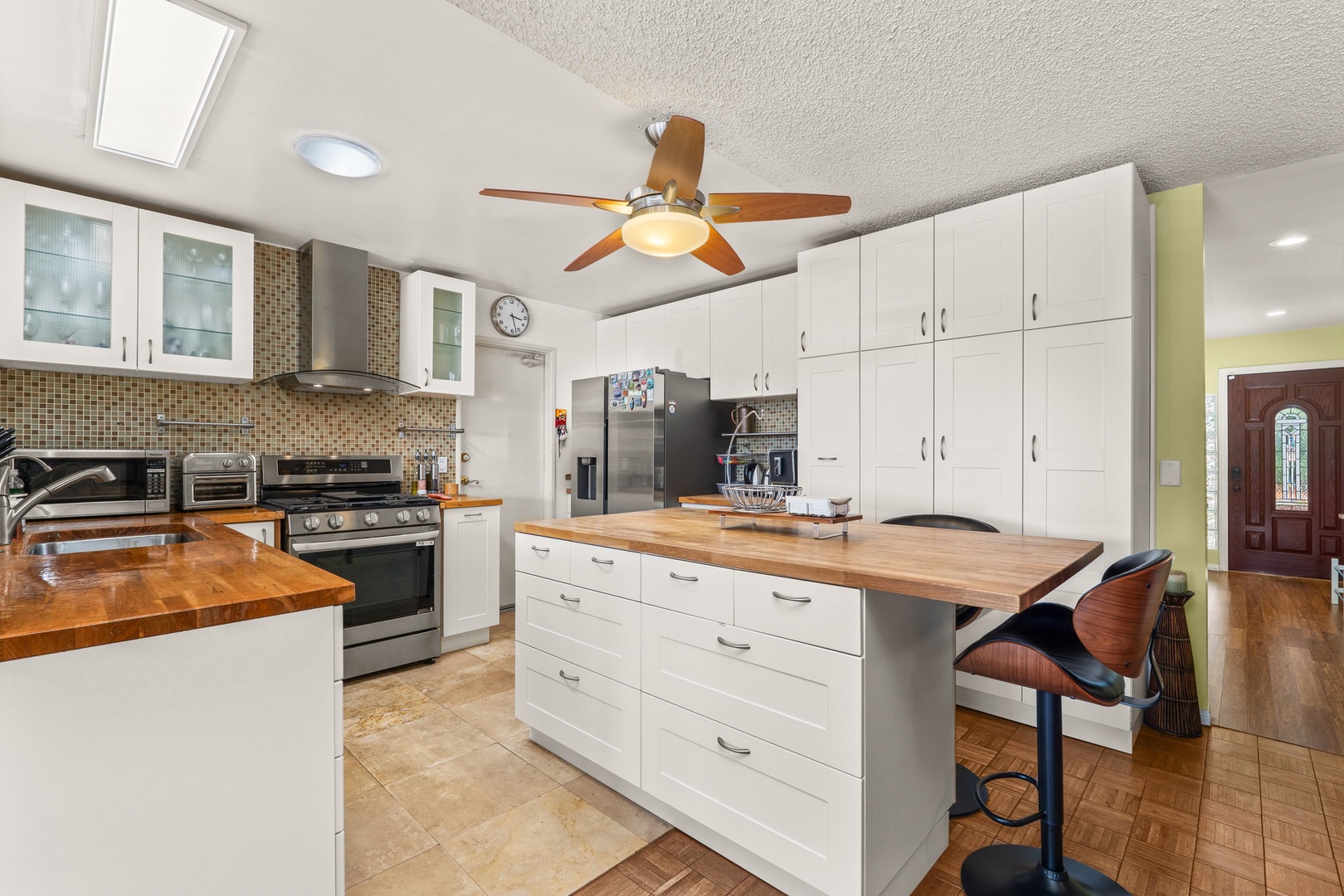 Your spacious kitchen invites culinary adventures with warm wood countertops, modern appliances, and an island perfect for morning coffee or evening conversations.