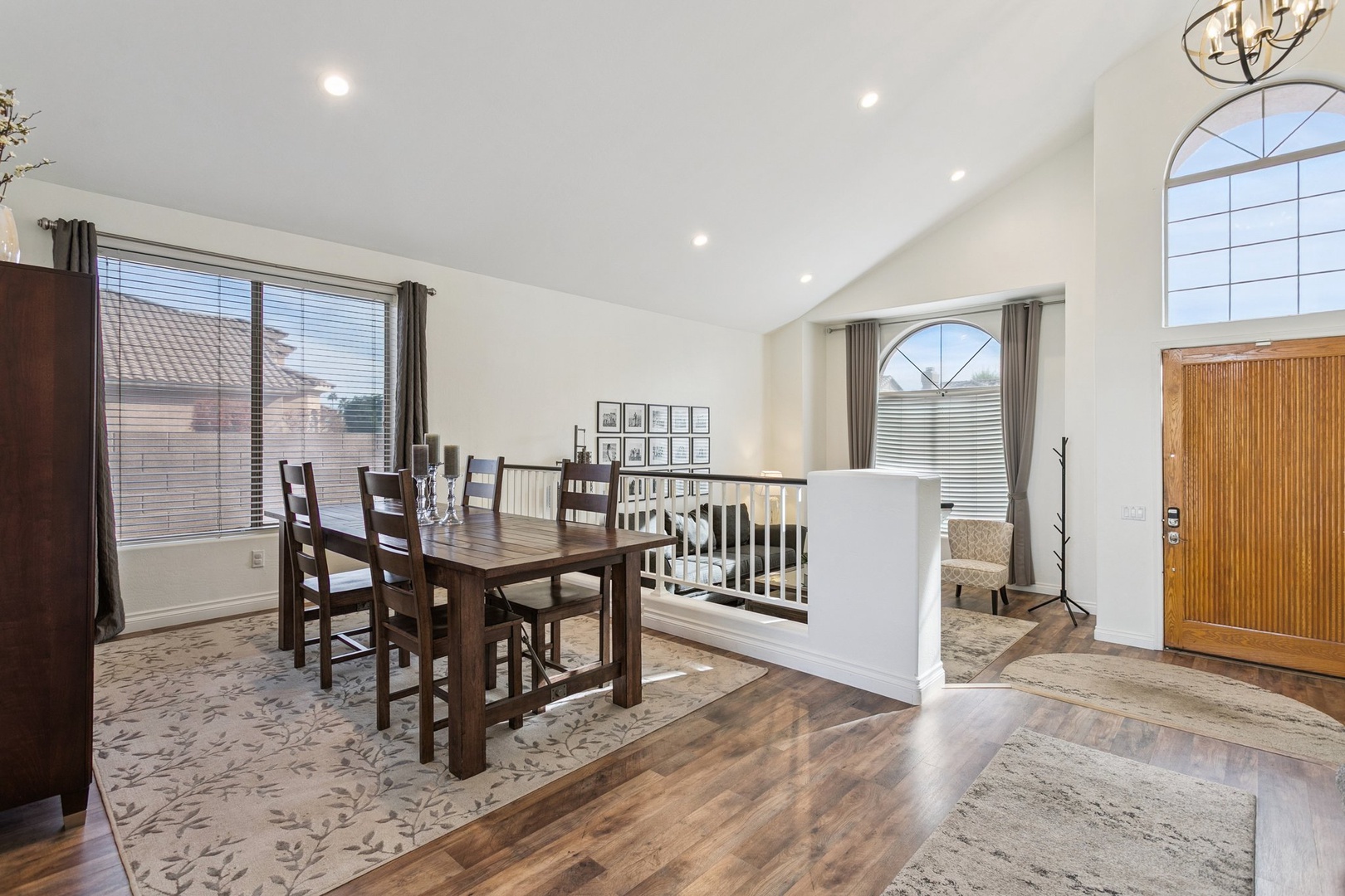 Your open-concept dining area flows seamlessly into the living space, with soaring ceilings and natural light creating an airy, welcoming atmosphere for memorable meals.