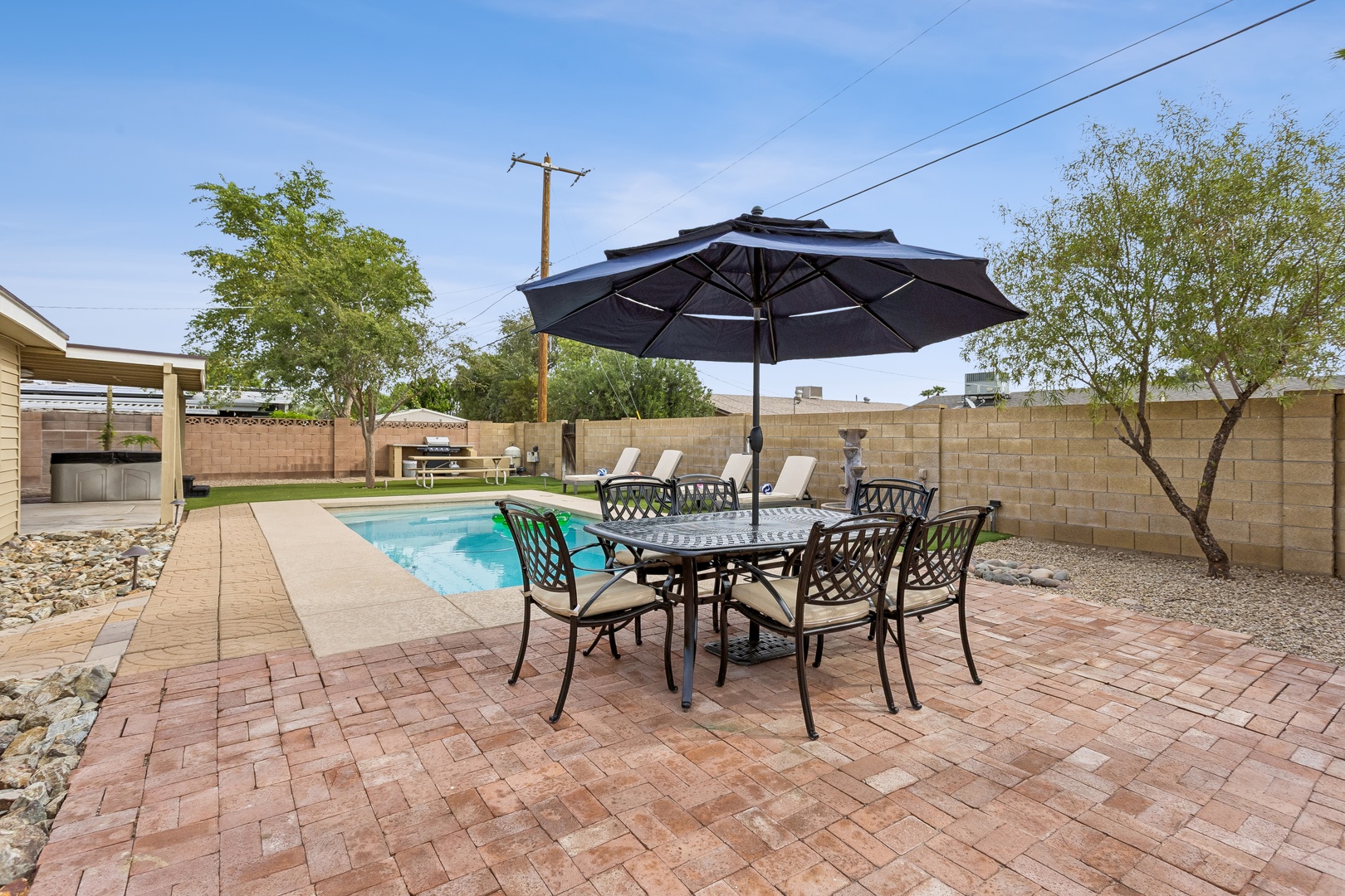 Your private backyard oasis awaits—sunny days by the sparkling pool, alfresco dining under the shade, and plenty of room to unwind beneath desert skies.