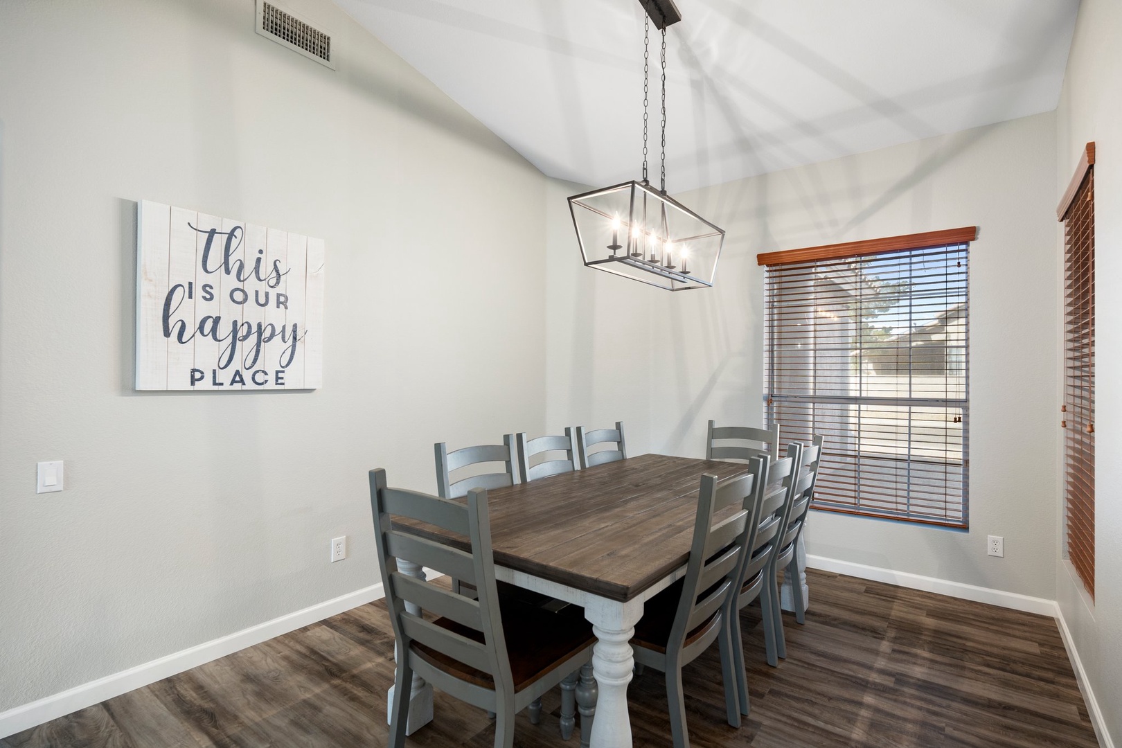 Gather around this spacious dining table where your group can share meals and stories under elegant lighting. The vaulted ceilings and natural light create a welcoming atmosphere for memorable dinners together.