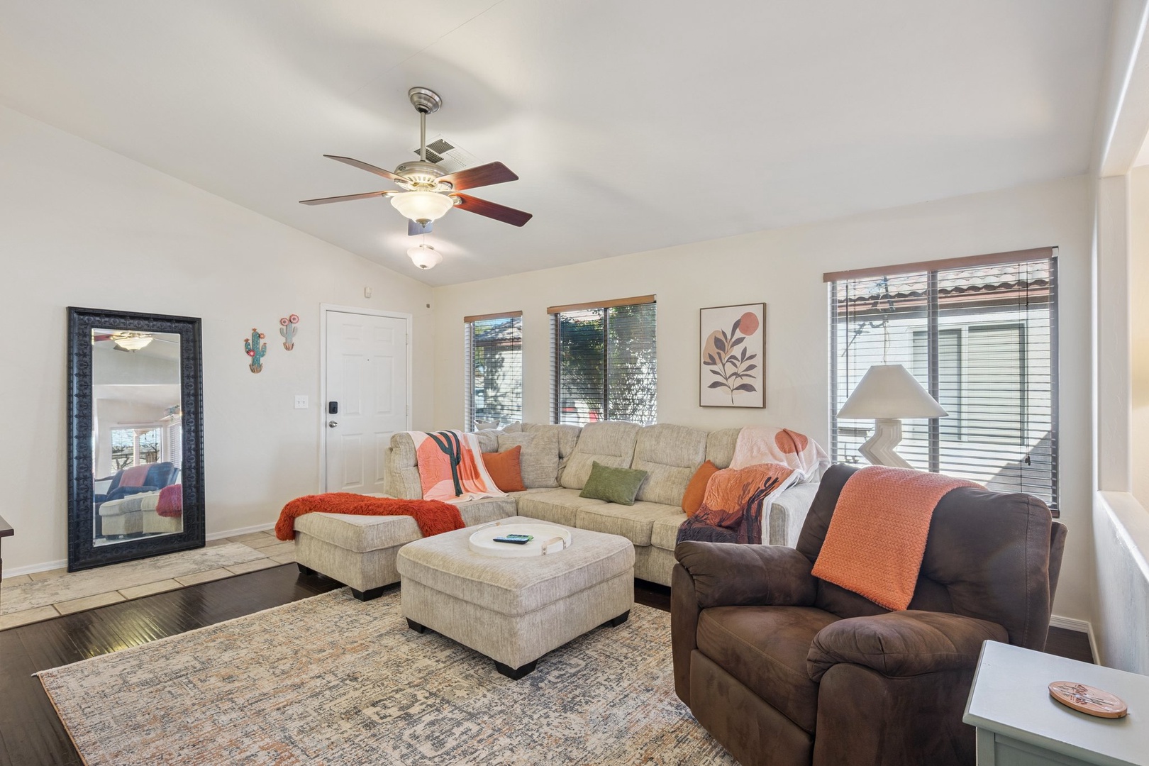 Sink into plush sectional seating while your ceiling fan circulates the perfect breeze in this bright, welcoming living space.