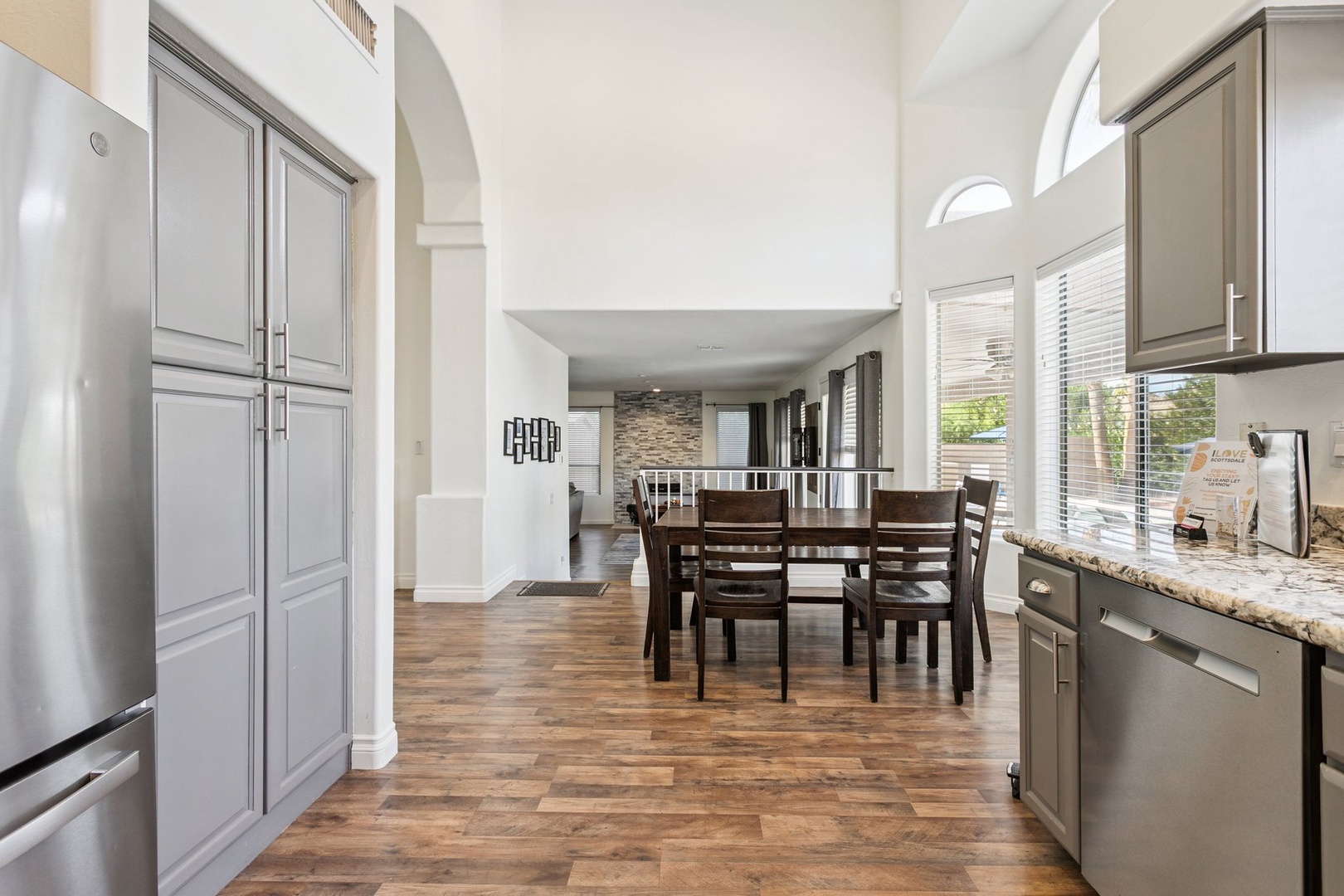 Your spacious kitchen flows seamlessly into the dining area, with gleaming appliances and rich hardwood floors creating the perfect space for cooking and gathering.