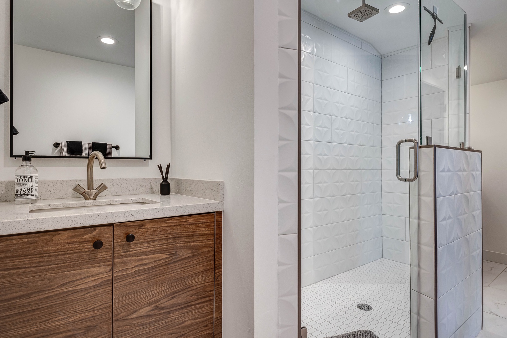 One ensuite bathroom, two full guest bathrooms, and one half bathroom stocked with items including: shampoo, conditioner, body wash, and fresh towels.