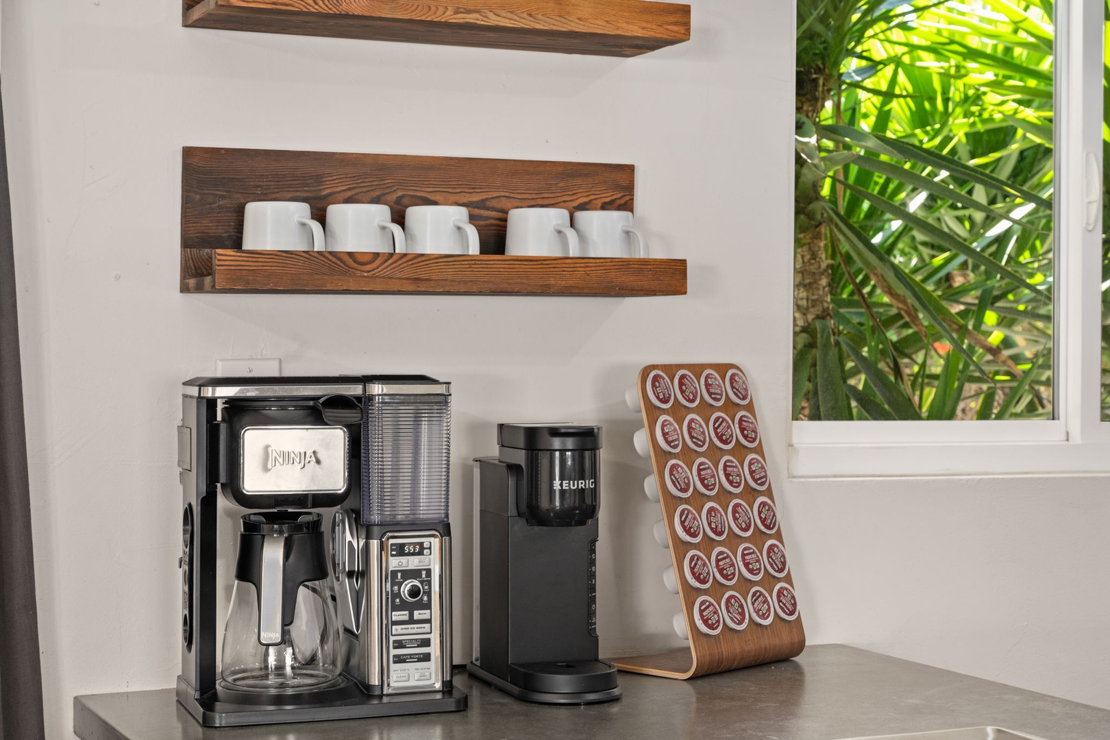 Start your mornings right with your own coffee bar featuring a Ninja brewer and Keurig, stocked with mugs and pods for your perfect cup.