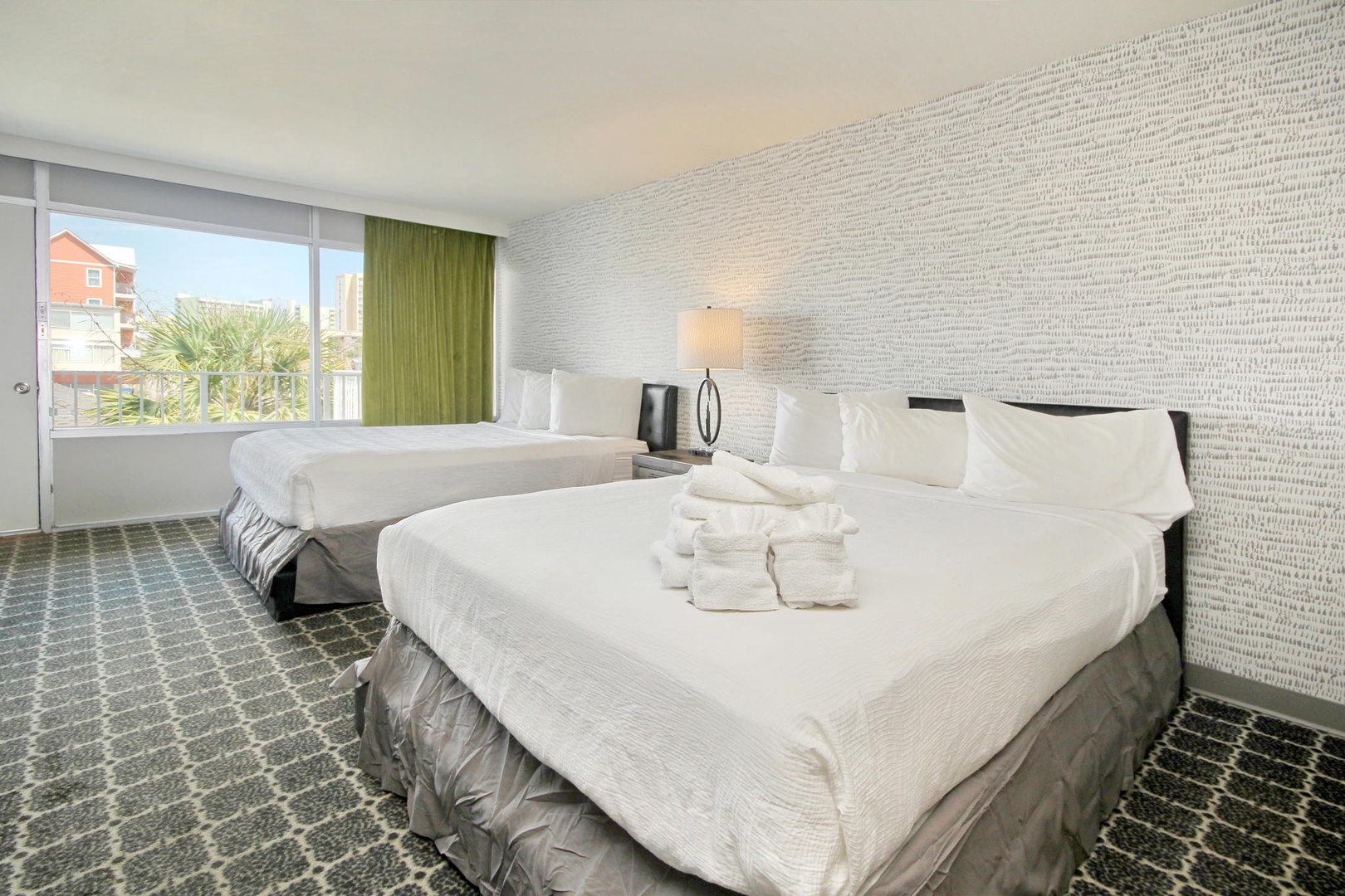 Bright and airy double queen bedroom