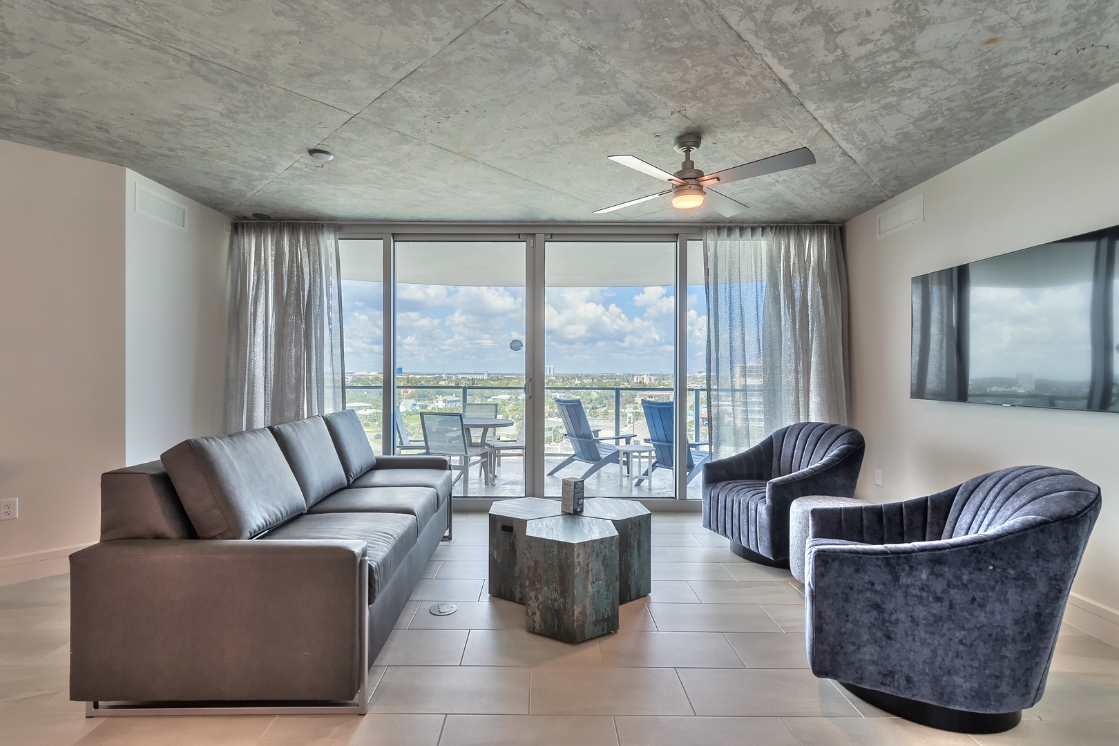 City Lights & Coastal Vibes: Relax in the Living Area with Urban and Ocean Backdrop