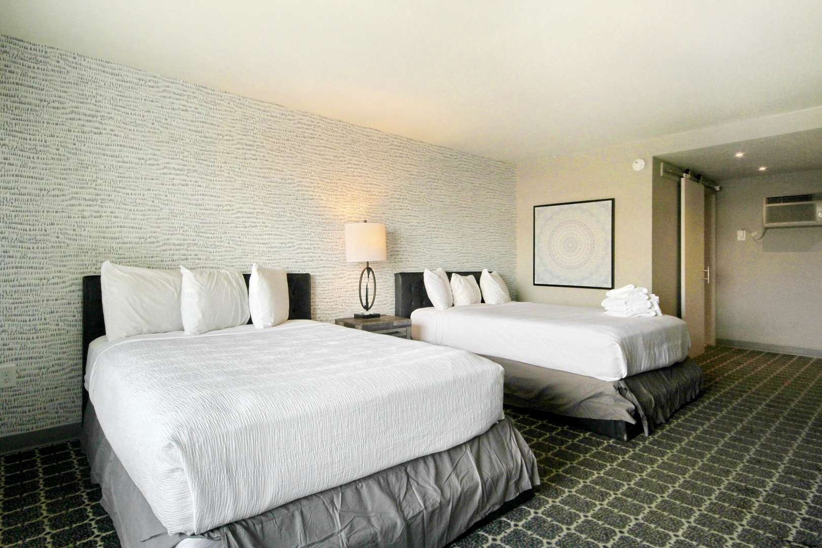 Bright and airy double queen bedroom
