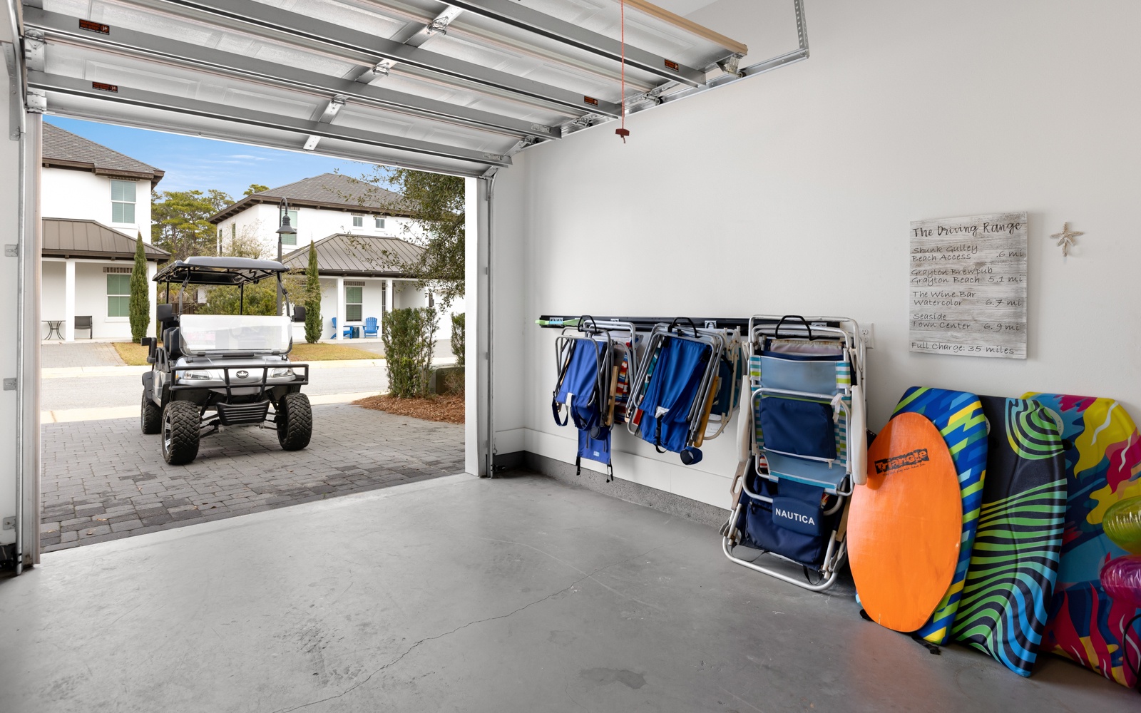 Your beach essentials are perfectly organized in this convenient garage space, complete with chairs, towels, and gear for your coastal adventures.