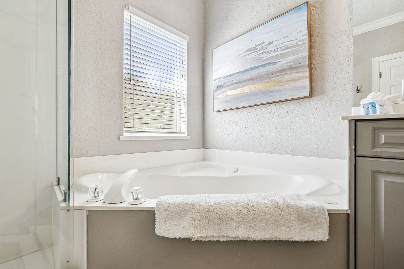 Unwind in your private soaking tub with plush towels and serene artwork creating the perfect spa-like retreat.