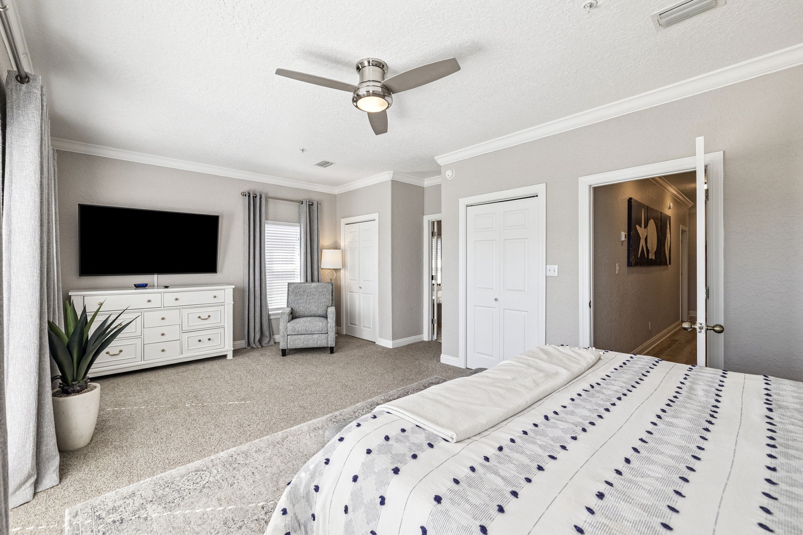 Unwind in your spacious master suite with plush carpet, a cozy reading chair, and entertainment center for the perfect bedtime ritual.