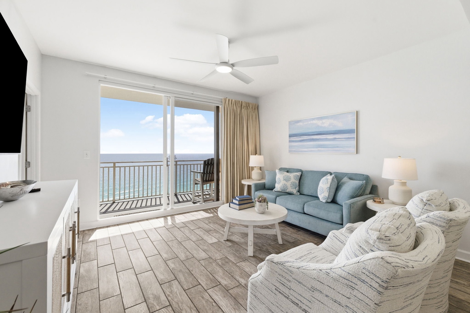 Sink into plush coastal seating while ocean breezes drift through your balcony doors and endless sea views stretch beyond your private terrace.
