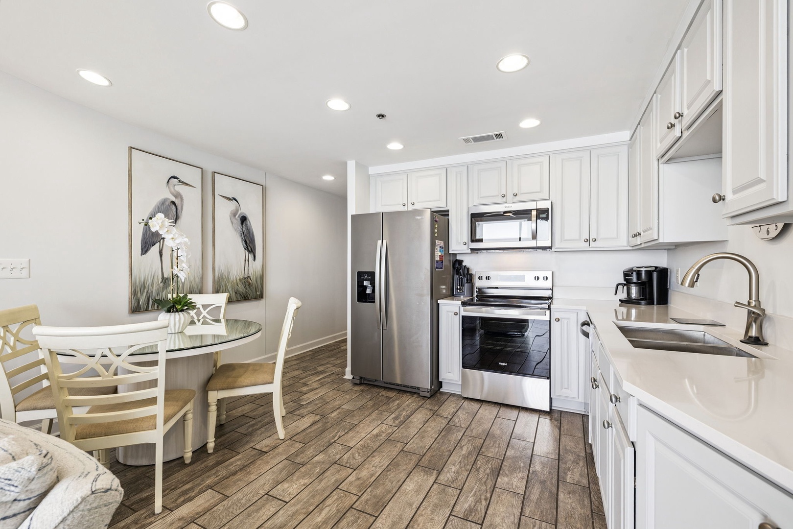 Your bright, fully-equipped kitchen invites you to create memorable meals with stainless steel appliances and elegant white cabinetry.
