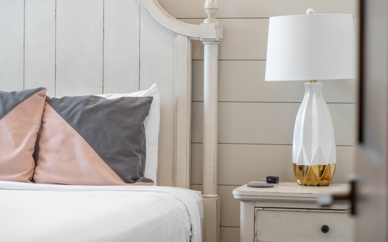 Sink into crisp white linens and soft pillows in your serene bedroom, where elegant white furnishings create a peaceful retreat.