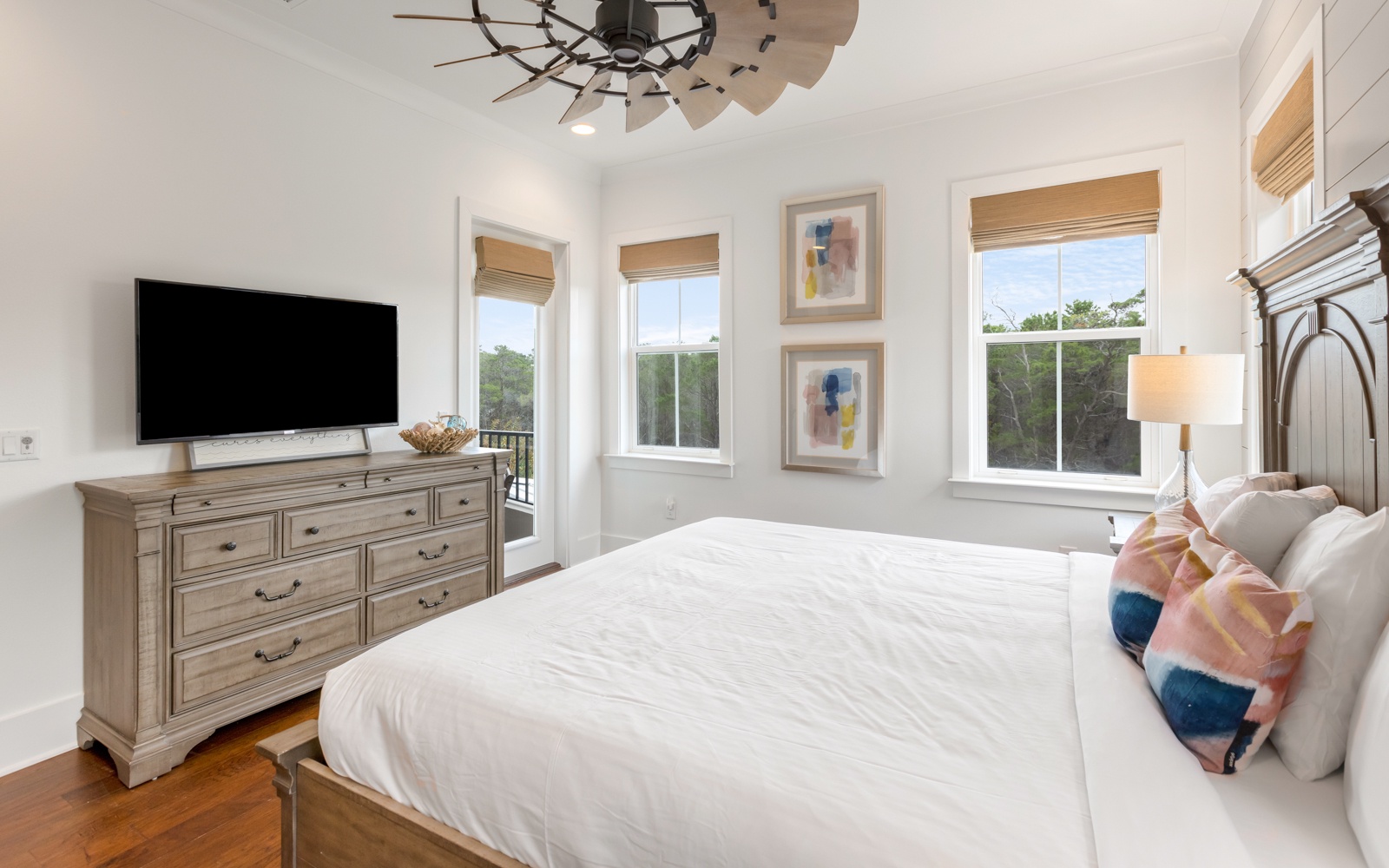 Wake up to natural light streaming through your windows in this serene bedroom featuring a plush king bed and modern amenities.