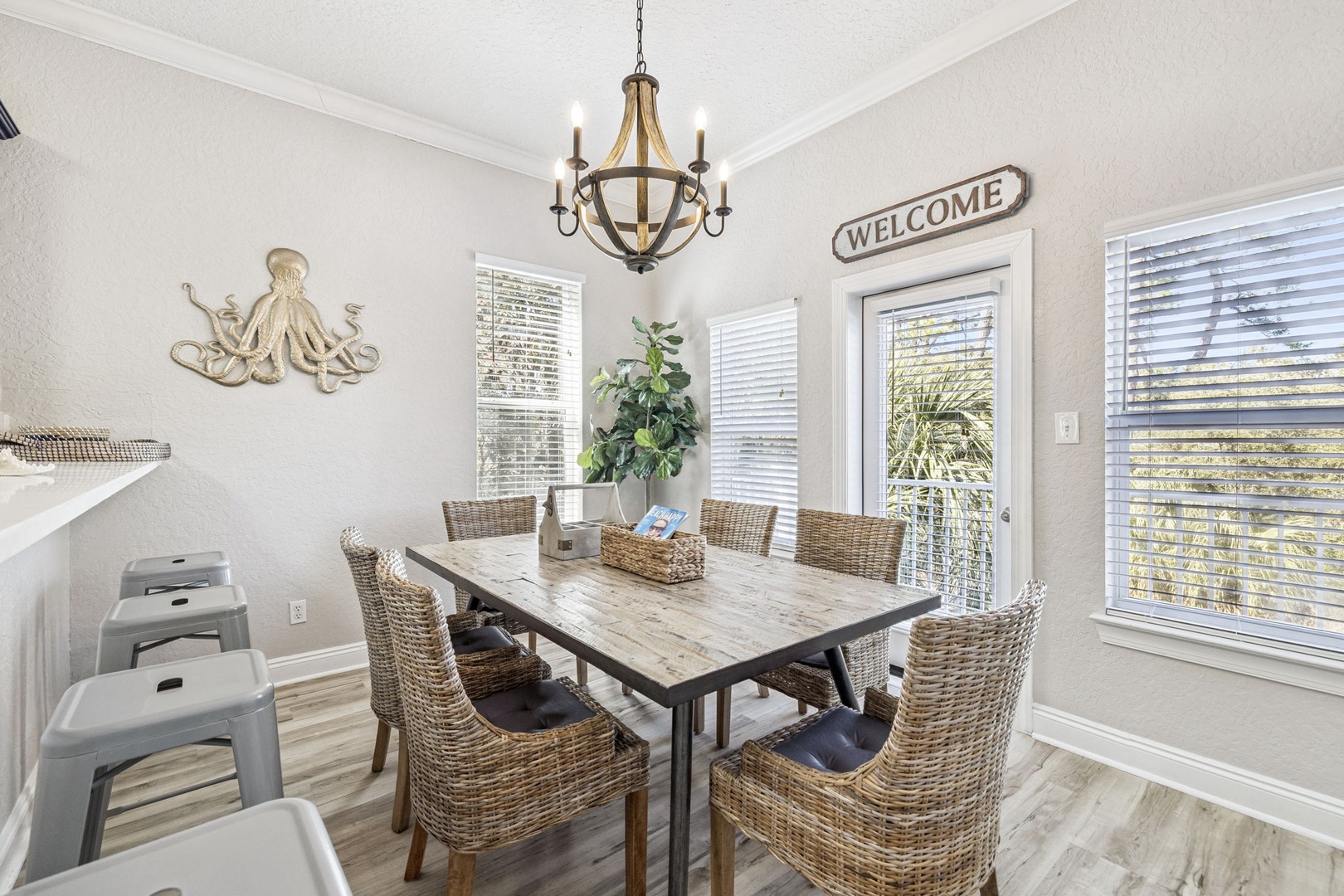 Gather around your coastal dining table for memorable meals under the warm chandelier glow, with nautical touches creating the perfect beachside atmosphere.