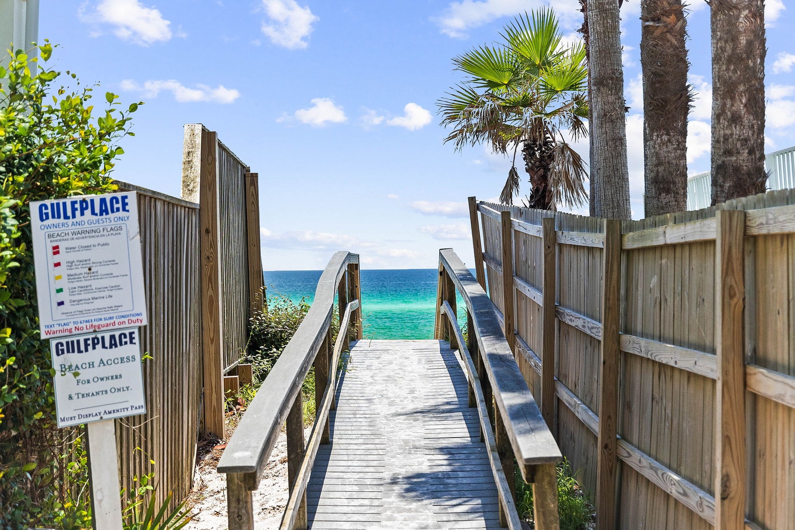 Private beach access walkway leading to crystal-clear Gulf waters and pristine white sand beaches.